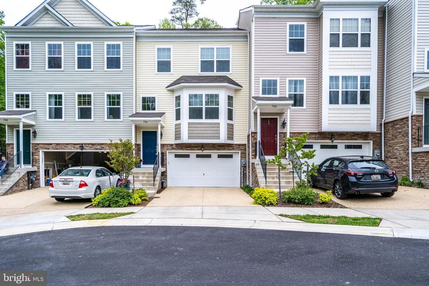 Discover this immaculate townhouse at 704 Pin Oak Ct in Prince Frederick, MD. Nestled in a serene cul-de-sac, this home offers a peaceful and quiet community living experience. The spacious layout includes a 4-foot bump-out on all three levels, providing extra space for comfortable living. The kitchen features granite countertops, an eat-in island, and an oversized pantry, ideal for cooking enthusiasts. The primary suite boasts vaulted ceilings and a luxurious super bath, creating a private retreat. Conveniently, the laundry is located on the bedroom level for easy access. The versatile lower level includes garage access, a wet bar with fridge, and a full bath, perfect for guests or a cozy movie night. With ample parking provided by the 2-car garage, there is plenty of space for vehicles and storage. Relax on the large private deck, which backs to trees, offering a perfect outdoor escape. Additionally, this townhome is in a great location, allowing you to walk to the commuter bus lot and enjoy proximity to top-rated schools. This townhome combines comfort, convenience, and tranquility, making it an ideal place to call home. Don't miss the opportunity to experience this exceptional property!
