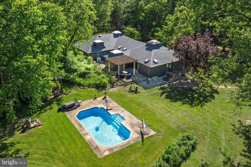 Welcome to 2436 Warm Springs Road! This sprawling estate located near Shepherdstown, WV, is comprised of over 17 acres and features the main house, guest house, pool, hot tub, gazebo, barn, shop/garage with an attached gym/game room, and multiple other buildings on the property. The main house offers 5 bedrooms and 3.5 baths, all on one level, and is highlighted by the gorgeous wood floors and cathedral ceilings with exposed beams and skylights that are found throughout the home. Heating and cooling are provided by an extremely efficient geothermal system.  Starlink has been installed and can be conveyed with the sale. This provides very fast and reliable internet service. There are over 2 acres of fenced yard surrounding the home, which gives plenty of space for pets to roam. There are also additional fenced areas where the owners currently keep their chickens and goats. The roof, siding, and gutter system on the main house were replaced in 2024. The smaller skylights were also replaced, and the larger skylights have been resealed. The well pump, water softener, and water line from the well to the home were also recently replaced. The septic was last pumped in September of 2024. The guest house provides an additional bedroom, full bath, and kitchen, making for a great place for friends and family to stay. The home had been utilized as a bed & breakfast in the past and could also have potential as an Airbnb. There is also potential for a builder to subdivide the site and build at least one additional home on the property. This amazing property has so much to offer! Please do not drive onto the property unless you have an appointment scheduled and are accompanied by an agent.