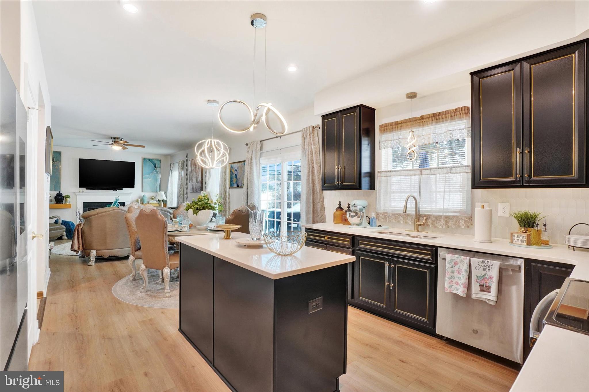 Modern sophistication meets thoughtful design in this expansive 3,000+ square foot home, offering four bedrooms, three and a half baths, and luxury upgrades at every turn. From the moment you step inside, you’re greeted by a dramatic two-story foyer illuminated by a statement chandelier—setting the tone for the refined elegance throughout. The main level is thoughtfully designed for both daily living and entertaining. Enjoy the inviting family room with a cozy gas fireplace, a formal living room perfect for gatherings, and an elegant dining room for special occasions. The eat-in kitchen is a showstopper—featuring sleek quartz countertops, upgraded cabinetry with soft-close features, contemporary pendant lighting, and a generous island that anchors the space. Double patio doors open to a large deck and manicured backyard, seamlessly blending indoor and outdoor living. Upstairs, the primary suite is a true retreat. Soaring coffered ceilings add architectural interest, while the spa-inspired en-suite bath offers a jetted soaking tub, walk-in glass shower, dual-sink vanity with quartz counters, and a spacious walk-in closet. Three additional generously sized bedrooms share a beautifully appointed hall bath, and an open balcony hallway provides a breathtaking view of the foyer below. The fully finished lower level is an entertainer’s dream—featuring a stylish media room with built-in sound, recessed lighting, and a full bathroom, perfect for movie nights or hosting guests in comfort. Built in 2022, this home offers the perfect blend of modern construction, timeless design, and luxurious finishes- all set against a backdrop of sweeping mountain views AND available at a value you won't find in comparable new construction builds.