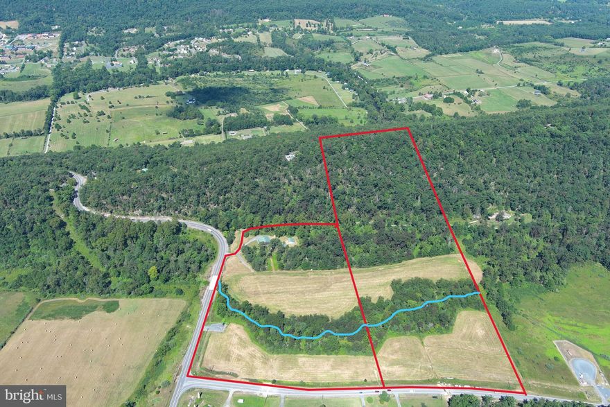 OVER THE LINE....NEARLY 41 ACRES WITH EVERY FEATURE ON YOUR WISHLIST; STREAM, VIEWS, PASTURE & WOODS. 40X60 BOARD & BATTEN GARAGE WITH LIVING QUARTERS & 40X36 MACHINE SHED....TOY STORAGE TO THE MAX....THE GARAGE/WORKSHOP IS MASSIVE, ABOUT 2800 SQ FT OF FLOOR SPACE WITH 10X60 WINGS ON EACH SIDE. FULLY FUNCTIONAL WITH ALL UTILITIES, CAMPER HOOK UP FOR YOUR GUESTS. PERFECT HOBBY FARM, 8 ACRE HAYFIELD & 8 ACRE FENCED PASTURE WITH 2 AUTOMATIC WATERERS. PLENTY OF WOODS TO HUNT, SHOOT & RIDE ATV'S. OVER 2000 FT OF "MILL BRANCH" FLOWS THROUGH THE LAND YEAR ROUND. MULTIPLE HOME SITES, SOME OF WHICH OFFER MASSIVE LONG RANGE VIEWS. OVER 150K IN IMPROVEMENTS BETWEEN THE BUILDINGS, UTILITIES, FENCING & INFRASTRUCTURE. WHEN YOU BACK OUT THE IMPROVEMENTS, IT PUTS THE LAND AT ABOUT $7300 PER AC, WHICH IS CHEAP FOR THE LOCATION & QUALITY OF LAND. COMPRISED OF 2 TRACTS; THE IMPROVED TRACT THAT FRONTS ON RT 50 & SMOKEY HOLLOW RD IS 20.096 ACRES AND IS TOTALLY UNRESTRICTED AND WOULD MAKE A GREAT COMMERCIAL BUSINESS LOCATION WITH IT'S HIGH VISIBILTY FROM RT 50. THE BACK PARCEL IS 20.859 ACRES KNOWN AS SECTION 3 OF OVERLOOK RIDGE AND IS SUBJECT TO COVENANTS AND ANNUAL $300 HOA DUES. LOCATION, LOCATION, LOCATION....LESS THAN A MILE FROM THE THRIVING VILLAGE OF CAPON BRIDGE, 2 MILES FROM THE VIRGINIA LINE AND LESS THAN 20 MINUTES FROM WINCHESTER, VA. IT'S JUST OVER THE LINE....BREAK FREE FROM OPPRESSIVE LAWS & HIGH TAXES, ENJOY THE FREEDOM & LOW COST OF LIVING THE MOUNTAIN STATE HAS TO OFFER. A UNIQUE PROPERTY WITH UNLIMITED POSSIBILITIES & UPTAPPED POTENTIAL.