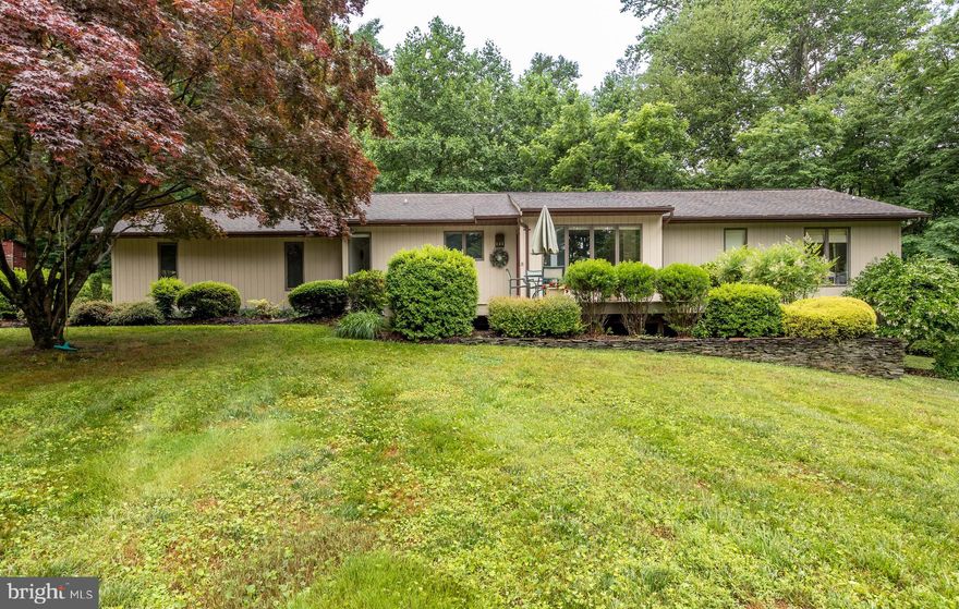 Very private,  Rancher in the country on 5 acres,  surrounded by woods yet 5 minutes to schools,  grocery store,  major commuter routes.  Original owners, well maintained  and cared for.  Very open floor plan  and  vaulted ceilings and lots of glass,  gives contempory feel.  Mostly  Hardwood  floors, carpet in  the bedrooms, ceramic  in the basement.  Bump-out  off the kitchen makes ideal space for kitchen table  with large windows and view of the front lawn and driveway.  Open decks front and rear for soaking up  nature in a very private setting.  Mostly open lower level with gas stove, workshop with walkout door, 1 bedroom and 1 full bath.  LL bedroom has 2 large windows giving the feel of an above grade room.