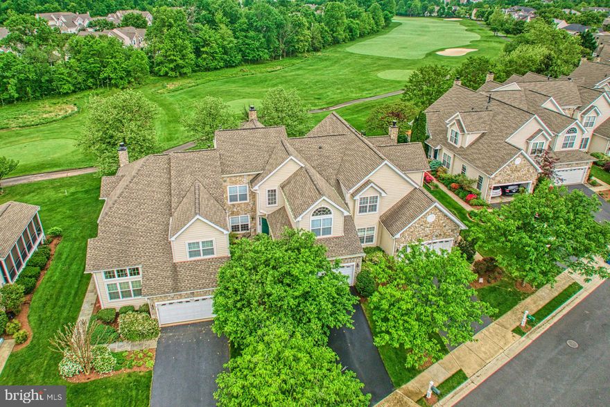 Welcome home to this beautifully maintained four level 'Victoria' model carriage home backing to the golf course in the highly sought after Belmont Country Club community. The custom walkway greets you as you walk up to the home & enter the two story foyer. Large dining room with upgraded chandelier opens to the grand two story living room with wall of windows providing tons of natural light. Spacious kitchen with updated appliances & eating area with access to the rear deck . The open concept living space also offers a cozy family room with fireplace. The main level features a renovated mudroom with built-ins & powder room too! Large primary bedroom with large custom closet & renovated bathroom with oversized walk-in shower. The upper level features two additional spacious bedrooms & second full  bath. The fourth level loft with skylight is an ideal from home space or library. The unfinished lower level is spacious & ready for future expansion. Incredible outdoor living space with deck backing to the golf course with incredible views & ideal entertaining space. Extended driveway, extensive landscaping, tankless water heater, new roof in 2018 & more! The monthly HOA Fee includes lawn mowing, high speed internet, cable TV, trash removal, community swimming pool, playground & more. This home is conveniently located nearly local dining, shopping, entertainment & commuter routes.