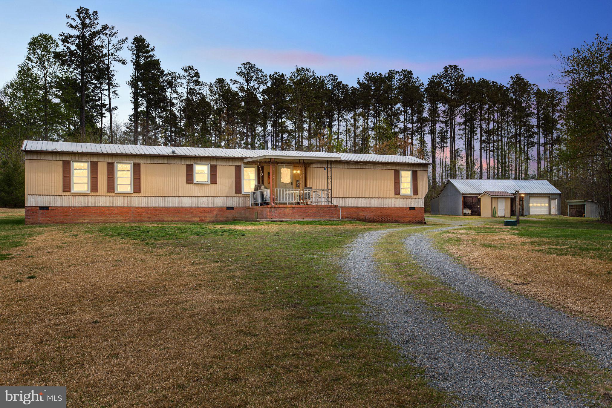 Welcome to this beautifully maintained home, peacefully nestled on nearly 5 acres of picturesque land at the end of a private road. Pride of ownership shines throughout, with thoughtful updates and meticulous care. A durable metal roof and HVAC system were both installed in 2017, along with updated windows for energy efficiency. The septic system has been professionally serviced within the last three years, and the HVAC received a routine service in April 2025. The main bathroom features recent upgrades including a new vanity, toilet, and flooring. Enjoy the benefits of an aquifer-fed well, housed in an insulated pump house, and a new well pressure holding tank. This move-in ready home is the perfect blend of privacy, comfort, and peace of mind—your private oasis awaits!
Outdoor features include a detached garage with three open bays and one enclosed bay—perfect for keeping vehicles covered year-round—as well as a separate shed for additional storage. Whether you're looking for privacy, functionality, or peace of mind, this move-in ready home has it all!