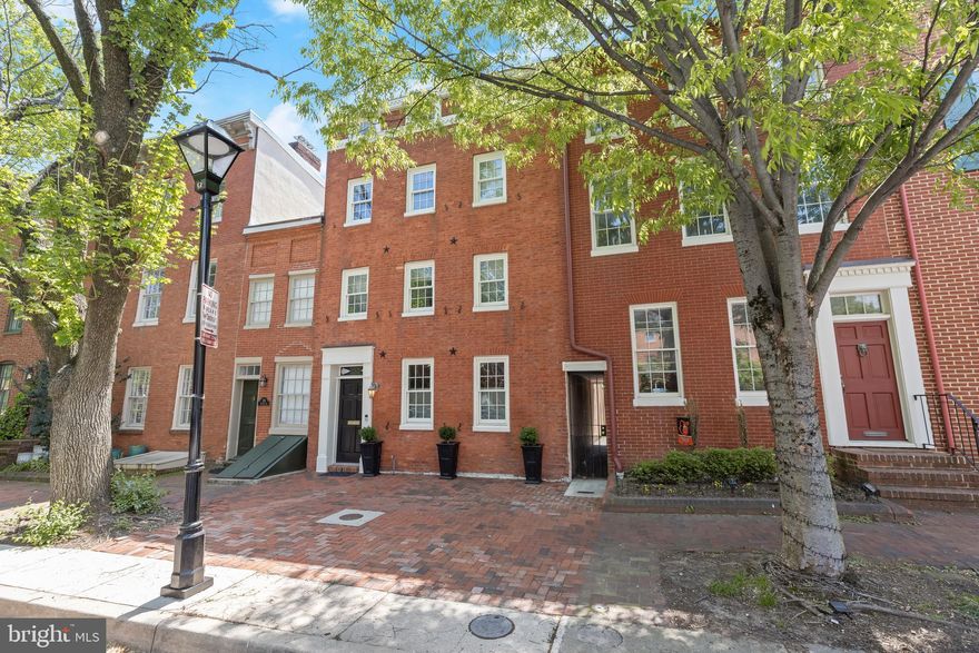 Welcome to a rare opportunity on one of Otterbein’s most coveted, picture-perfect streets—where timeless charm meets modern, move-in-ready living.
From the moment you step inside, you’re greeted by a light-filled, open-concept main level that instantly feels like home. The seamless flow between the living, dining, and kitchen spaces creates the perfect backdrop for everyday living and unforgettable entertaining. Rich hardwood floors, recessed lighting, and an abundance of windows make the entire space feel bright, airy, and inviting.
At the center of it all is a show-stopping kitchen designed for both function and style—featuring an oversized island with seating and storage, a built-in wet bar, granite countertops, and stainless steel appliances. Whether you’re hosting a crowd or enjoying a quiet night in, this space delivers.
The adjoining family room, complete with surround sound, opens to a beautifully landscaped private stone patio and garden—your own outdoor oasis. Think summer dinner parties, cozy evenings, or a peaceful morning coffee… this is the kind of space you’ll actually use.
Upstairs, the second level offers a spacious primary retreat with a large walk-in closet outfitted with custom built-ins. A full bath with double vanities and a walk-in shower, a dedicated laundry room, and a second bedroom complete this level.
The third floor adds even more flexibility with two additional bedrooms and another full bath—ideal for growing households, guests, or work-from-home setups.
An unfinished basement provides ample storage and room to expand if desired.
Major updates have already been taken care of, including HVAC, roof (2024), water heater (2021), refrigerator (2024), dishwasher (2023)—offering peace of mind from day one. Plus, enjoy the convenience of two residential parking permits and two guest passes for easy on-street parking. 
And the location? It’s hard to beat. Enjoy walkable access to neighborhood parks, cafés, stadiums, and the vibrant Inner Harbor—all while living on one of the most desirable streets in the neighborhood.
There is convenient access to the Camden MARC station for Washington DC commutes.  Homes like this don’t come along often. Don’t miss your chance—schedule your private tour today.