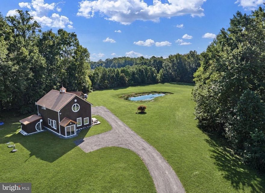 Home is occupied. Do not drive up private driveway without an appointment please. Thank you!

Nearly 18 acres of private, serene land await you at this unique Dover property—offering endless possibilities for those seeking a homestead, peaceful retreat, romantic getaway, or a comfortable place to downsize. Enjoy your own pond—perfect for stocking and spending quiet days fishing—and take advantage of the wide-open space ideal for raising animals, gardening, or even creating your own small farm. The land offers flexibility to truly make it your own.
The charming barn-dominium is exceptionally well built and meticulously maintained, featuring custom hardwood floors crafted from planked red oak milled directly from the land—adding a rare and personal touch you won’t find elsewhere. The home continues to showcase thoughtful craftsmanship with a handmade red oak countertop in the half bath, as well as a stunning large work table/bar complete with two oversized Lazy Susans—perfect for gathering, entertaining, or everyday living.
Outside, the property is just as functional and inviting. Two sheds provide excellent additional space—one large shed with a loft for storage or workshop use, and a second smaller shed behind the home that could easily be converted into a cozy office or studio, with heat and air access available via the nearby mini split connection. A small detached wood deck creates the perfect setting for relaxing evenings, whether enjoying bonfires or taking in the peaceful nighttime surroundings.
A shared driveway enhances both convenience and community, with neighbors who take pride in maintaining the road, plowing snow, and looking out for one another. There’s even a cooperative spirit of sharing firewood when needed, creating a safe and supportive environment. Just outside, the home is equipped with a powerful wood-burning fireplace capable of heating the entire home, and it comes with nearly half a cord of ready-to-burn wood—helping keep heating costs low.
This property offers the appeal of off-grid-style living while still benefiting from a connected, neighborly community of three. If you’re looking for privacy, functionality, and charm all in one, this is a rare opportunity you won’t want to miss.