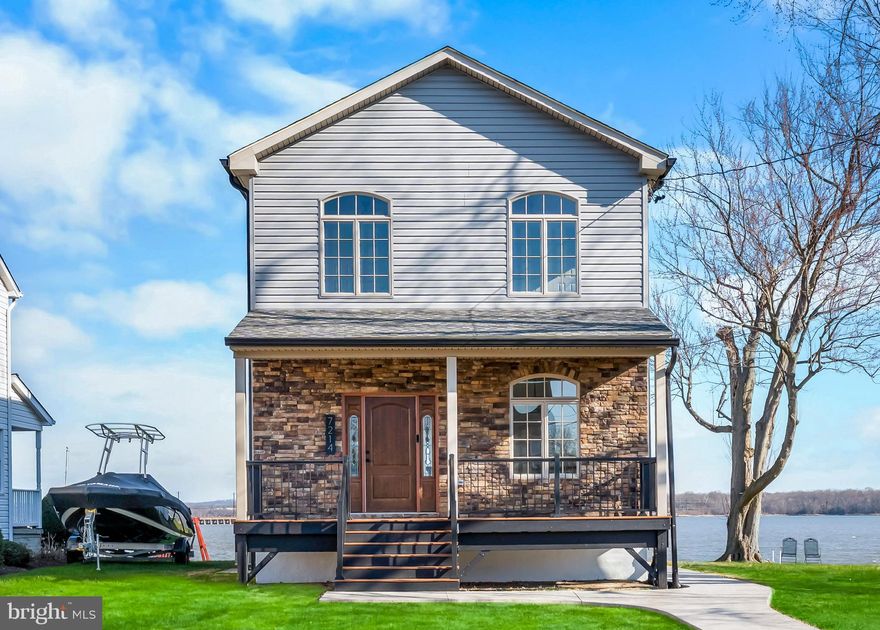 Wake up to panoramic views of the Gunpowder River in this fully renovated, move-in-ready waterfront home where modern design meets effortless coastal living. Built in 2015 and renovated top-to-bottom, this elevated property offers peace of mind with no flood insurance required. Inside, you’ll find a bright, open layout with wide-plank hardwood floors, a coffered ceiling, and a wall of Andersen sliding glass doors that frame the water and flood the home with natural light. Step outside to a spacious rear deck that leads to your private 100ft dock with  4 ft water depth and 50 ft of direct waterfront—perfect for boating, jet skis, or simply enjoying the view. Upstairs, the primary suite features a private balcony overlooking the river and a custom-built-in closet system. Bathrooms carry a clean coastal aesthetic with fully tiled showers, glass sliding doors, and subtle nautical finishes. Additional highlights include an unfinished basement ready for customization, 4-car parking, a storage shed, and strong curb appeal. This isn’t just a home, it’s a waterfront lifestyle. Opportunities like this on the Gunpowder River with modern construction, deep water access, and no flood insurance are rare.