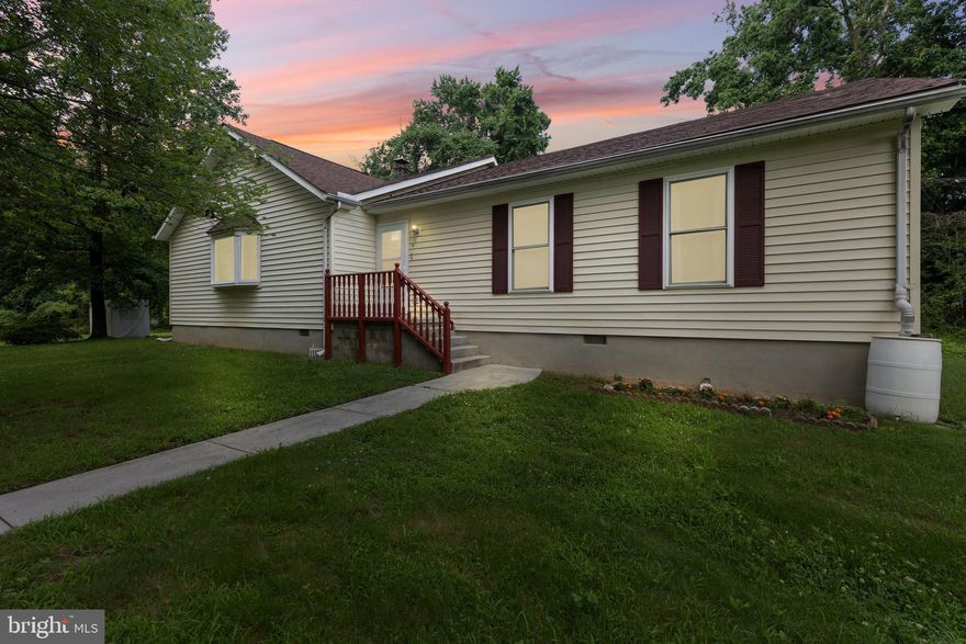 Tucked away in Glen Burnie, this charming 3-bedroom, 2-bath rancher offers one-level living with thoughtful updates throughout. Originally built in 1940 and fully rebuilt in 1999, the home features an open layout with durable laminate flooring, a freshly painted interior, and a modern kitchen outfitted with gray cabinetry, granite countertops, and stainless steel appliances (all updated within the last five years). Both bathrooms received new flooring in 2025, and a whole-house water treatment and filtration system adds peace of mind. Additional updates include a 2017 roof and furnace, 2011 hot water heater, 2022 gutter guards with transferable warranty, and even a pressure washer for added convenience. Outside, the private lot provides space between neighbors, a rear wood deck for relaxing or entertaining, and a one-car detached garage (as-is, no door) with a shared driveway. Combining classic character with modern comfort, this well-maintained home is close to everyday amenities while still feeling like a quiet retreat.