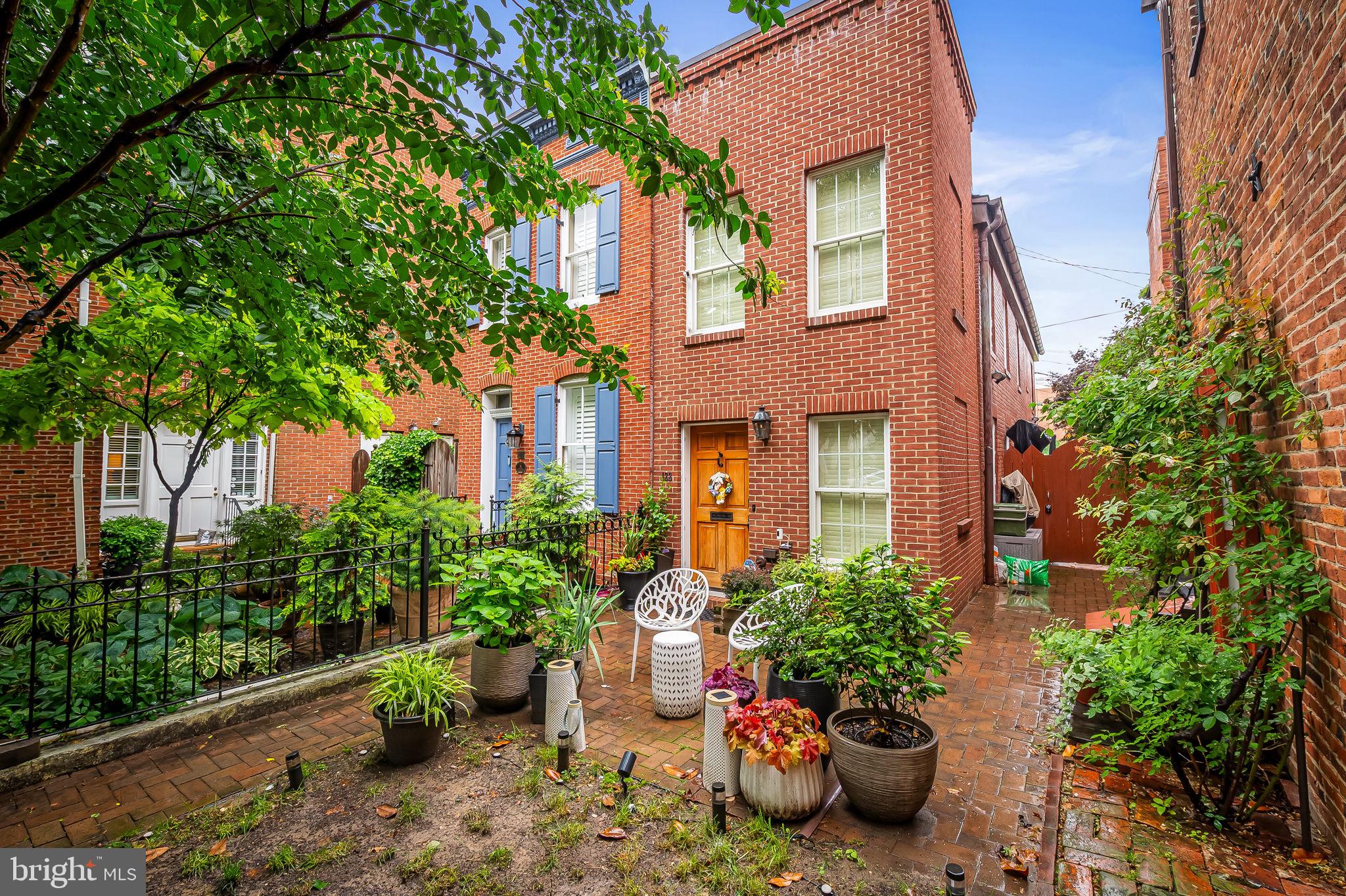 Situated on a picturesque cobblestone street at the foot of historic Federal Hill, this beautifully renovated rowhome blends original character with modern luxuries. This home is truly one-of-a-kind and features a private front yard AND an elevated rear slate patio with stunning WATER and CITY views perfect for entertaining. Inside you'll find high-end finishes from top to bottom including exposed brick, hardwood floors, crown molding, custom plantation shutters, window shades, recessed lighting w/dimmers and a custom-built bar w/wine fridge. The gourmet kitchen features fantastic harbor views and contemporary finishes with a Sub-Zero refrigerator, a gas stove, deep depth brass sink, granite countertops and under kitchen cabinet lighting. The breakfast area boasts a custom-built corner banquette and table with built in storage. The 2nd level features the master bedroom and secondary bedroom complete with custom designed closets and a full bath with luxury finishes. Exterior features include historical gas light fixture, keyless entry front door, gated wrought iron front yard fence, front green grass lawn, exterior lawn and tree accent lightening with timer, composite slate lifetime roof shingles, copper gutters and motion-activated exterior lights. Walk to absolutely everything including the waterfront, newly renovated Cross Street Market, coffee shops, restaurants, Federal Hill Park, Riverside Park, Fort McHenry and more! Perfect for the commuter with easy access to 95, walking distance to downtown, Camden Yards, and the Ravens Stadium. Welcome home!