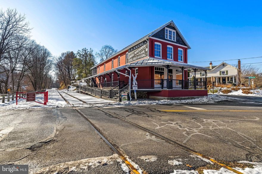 Ever dreamed of owning an entire village and a destination? This 5 property package offers that opportunity! 

Approximately 6,600 square feet of meticulously restored historic commercial space sits directly on the Heritage Rail Trail in Southern York County and is zoned to do something no neighboring property can. The Train Station at Seitzland Village is structurally complete, geothermal heated, and ready for final build-out. Heated walkways and stairs, wide open interior spaces, and a platform presence along one of Pennsylvania's most traveled recreational corridors make this a genuinely irreplaceable commercial asset.

The Historic Village Overlay (HVO) zoning that governs this property is the real story. In a region defined by strict residential zoning, the HVO was specifically structured to support tourism-driven commerce. Approvals are in place for micro-brewery, distillery, cafe, winery, restaurant, dining, bed and breakfast, and boutique retail uses - including bike and outdoor gear. You cannot replicate this entitlement position elsewhere in this corridor. You can only buy this one.

This offering is a package sale. The Train Station anchors Seitzland Village, a five-property portfolio assembled and restored by the late architectural artist Dave Keller. Supporting the commercial anchor are four residential structures that provide immediate and ongoing income: the Nicholas Seitz Stone House, an 1848 fieldstone home currently operating as a short-term rental; the Green House, a 1 bed / 1 bath Airbnb under renovation; the Original Seitzland Hotel, an approximately 2,200 sq ft building operating as a 2-unit long-term rental; and the Blue House, a structurally intact value-add property ready for redevelopment.

The customer base is already here. The Trail sees over 263,000 visits annually, with the heaviest concentration of users falling in the 55-65 age bracket - established, discretionary spenders with limited options to eat, drink, or shop between Glen Rock and New Freedom. The Northern Central Railway, operating adjacent to the property, logged over 20,000 passengers in 2025, up 15% year over year, with more than half arriving from outside York County.

Current ownership has completed the heavy lifting: acquisition, consolidation, zoning approvals, and structural restoration. The incoming buyer steps into a shovel-ready ecosystem with existing income in place and multiple paths to a high-revenue destination business.