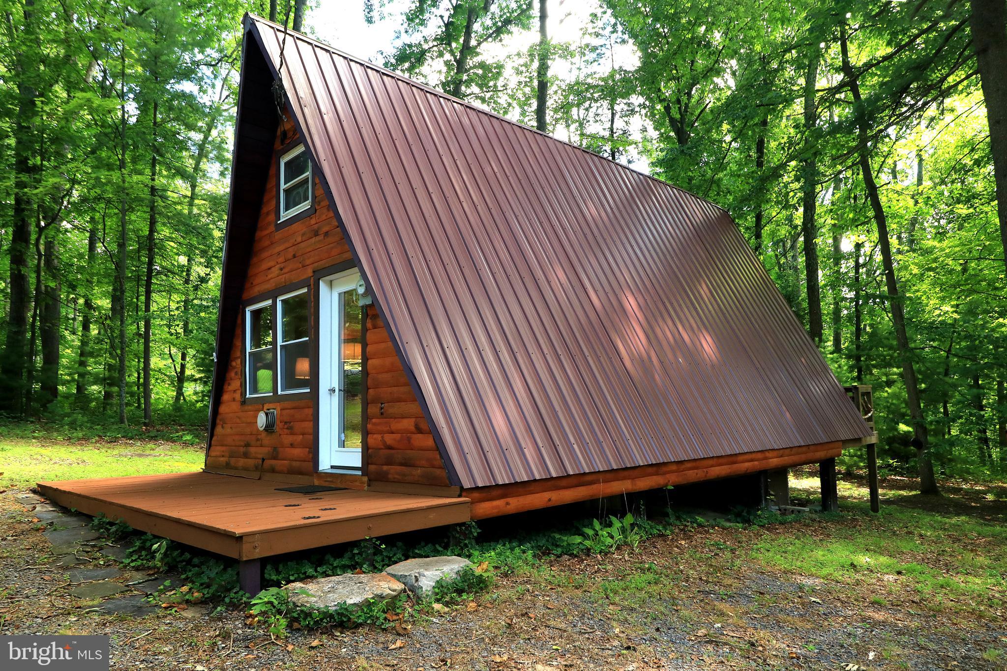Stellar A-frame retreat! You’ll love the craftsmanship that went into this recently renovated top-to-bottom overhaul. Step into the open-concept first floor and take in the stunning views of your private, wooded backyard. A cozy lofted sleeping area adds charm, while the partially covered deck offers the perfect spot to sip your favorite drink and listen to the birdsong and rustling leaves.
Modern conveniences like on-site water and electricity ensure comfort without compromising the serenity of your getaway. Everything you need is tucked neatly into the woods—ideal for relaxation or adventure.
When you’re ready to explore, you’re close to hang gliding, hawk-watching and birding opportunities, Juniata River access in McVeytown, and Greenwood Furnace State Park for boating, fishing, and swimming. Even Raystown Lake and Penn State University are an easy drive! Plus, nearby State Game Lands offer excellent hiking and wildlife spotting.
Whether you're an outdoor enthusiast or just looking to unwind, this location offers the best of both worlds. Call today for your private tour!