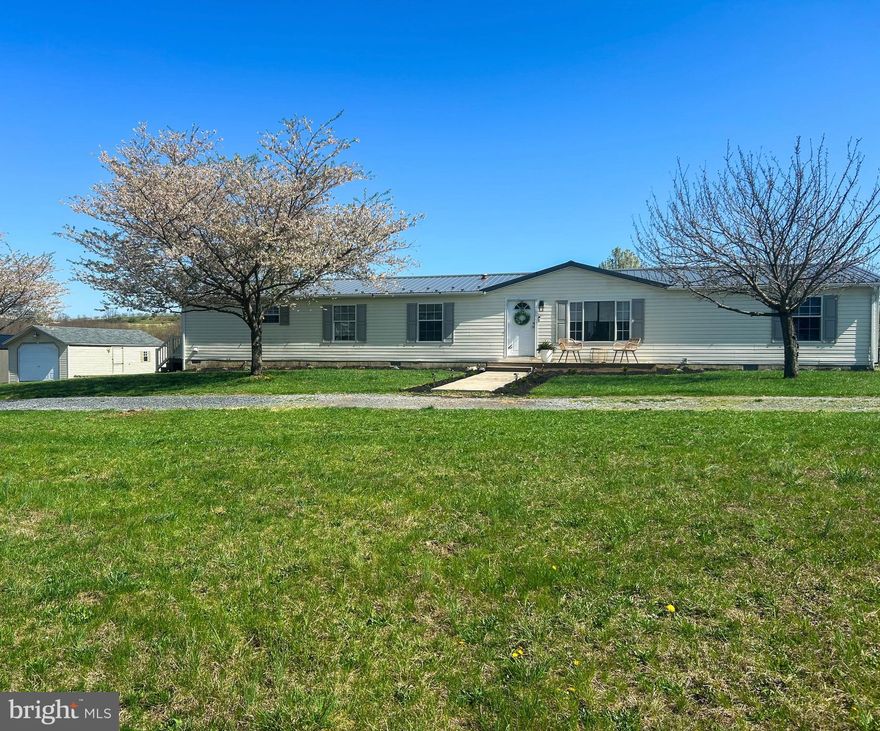 THERE IS SO MUCH TO LOVE about this beautiful 4-bedroom home on 1.39 pristine and unrestricted acres in Gerrardstown! This spacious home has had many recent upgrades, including a brand-new HVAC system, inside and out, including all-new ductwork; the primary bathroom has been updated with a generously large new, beautifully-tiled shower with a seat, dual shower heads and handrails, as well as a brand-new double vanity; the entire deck was replaced with Trex decking, which includes a wheelchair ramp which leads to a new concrete sidewalk; the flooring has been replaced throughout with gorgeous LVP, and it has a beautiful newer metal roof! The home has lots of windows which let in abundant natural light, and also has a split floorplan design where the large primary bedroom is located across the home from the 3 generous secondary bedrooms, and the home actually has two separate living rooms, one with a lovely stone-surrounded woodburning  fireplace.  The property is adorned with a large garage-like shed with a garage door and wood flooring, which could be easily converted to a one-car garage but is currently used as a storage space. This is a home where you can host large family gatherings or get cozy on cold winter nights – this home has it all! Schedule your showing today!