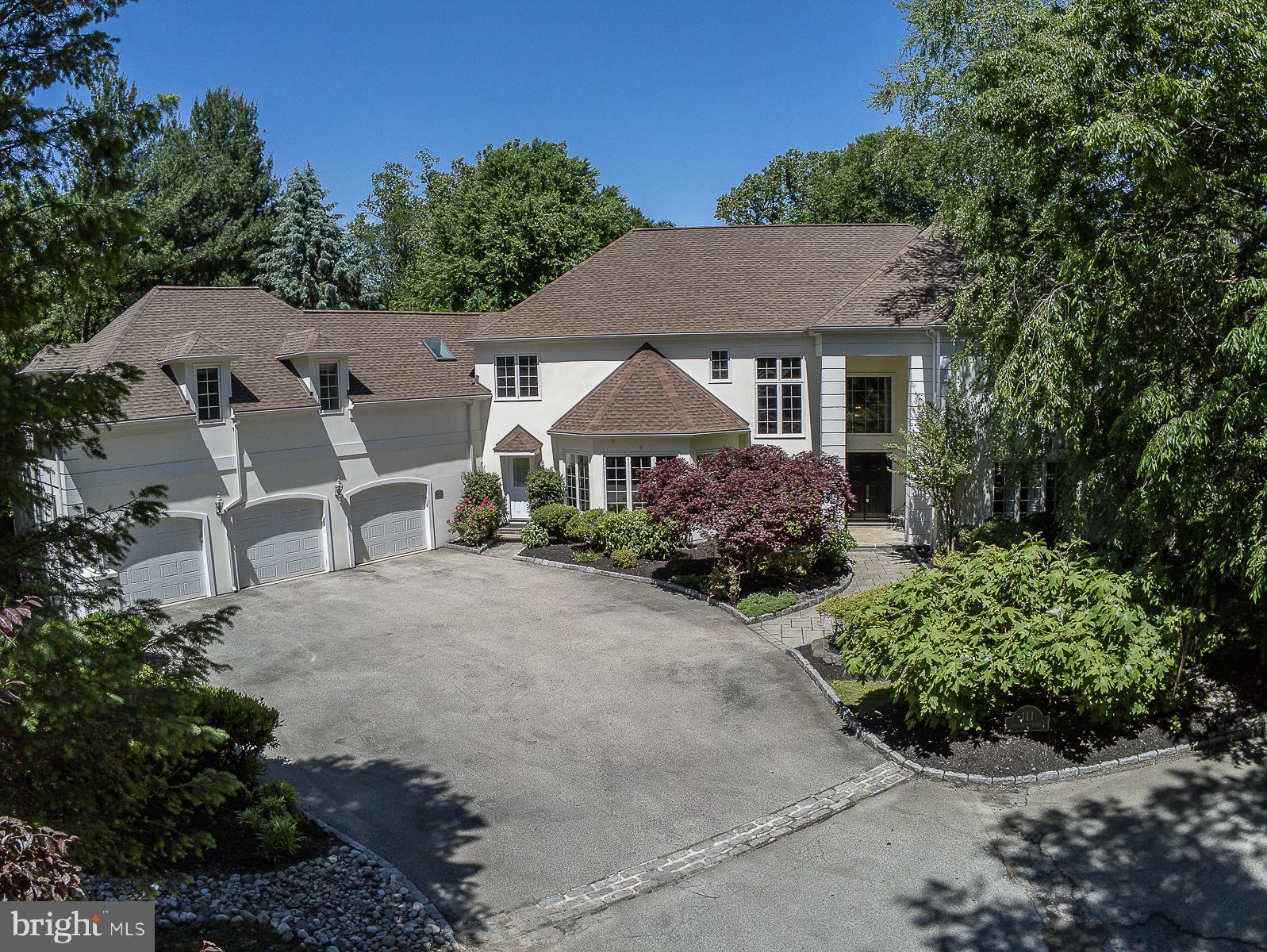 111 Fairview Road is situated on over an acre of private grounds in the heart of Penn Valley. This beautiful home offers great comfortable living in the most private setting in Lower Merion Township. Set on an interior lot, this home is surrounded by mature trees offering picturesque views from every window. As you enter into the 2 story marble foyer drenched with sunlight, you are welcomed into this open floor plan with a grand staircase centering the home. Main level offers a formal living room with fireplace, large den/office with built in's, cozy fireplace and wet bar overlooking spacious backyard, open 2 story family room centered by gas fireplace with large open windows, formal dining room surrounded with floor to ceiling windows, spacious eat in kitchen with Cook top Island and stainless steel appliances leading you to large wrap around Trex deck allowing for complete privacy. Main level laundry, 2 powder rooms on either side of main level, walk in pantry and entrance to 3 car garage complete this fabulous level. High end surround sound system is installed on deck, kitchen, living room and master bedroom! There are Hardwood floors throughout except for marble foyer. Second level offers large Master Suite with double sink, soaking whirl pool, his/her walk in closet and coffered ceiling. Balcony overlooking family rooms leads to three other very generously sized bedrooms, 2 bathrooms (two en-suite) with lots of storage and abundant closet space. Lower level is walk out to EP Henry patio under over-sized Trex deck. Huge recreation area with 4th fireplace (gas), 5th bedroom with double closets, full bath and lots of unfinished space for storage. This home offers over 6,000 SF of living space with generous room sizes and perfect for entertaining all year around. The exterior yard is private and surrounded by mature trees not overlooking any neighbors! Lots of other perks and special touches as you walk through this well-built sun drenched home that is just minutes to the Township Elementary and Middle schools. Perfect sized home for everyone and centrally located! Minutes to Center City, Narberth Train Station, Manayunk shopping and dining, and other Main Line establishments.