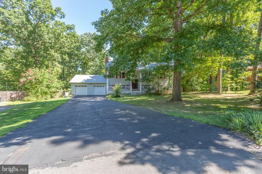 This 4 Bedroom, 3 Bathroom Split Foyer with sprawling front porch is ready for new owners! On the main level you with find a beautiful kitchen space with huge island featuring a wine fridge, stainless steel appliances including a smooth top stove & double oven. The kitchen opens to a space that can be used as a dining room or living room with wood burning fireplace. Down the hall is a Primary bedroom with attached bath, two additional bedrooms and a second full bathroom. Bedroom 2 is currently utilized as a walk-in closet. On the lower level you will find a family room with gas fireplace that opens to the backyard, bedroom 4 and the office or den space. Additionally there is a laundry/utility room.  The backyard is picturesque  with vinyl decking, patio with fire pit, fenced in and an area set up for your future hot tub. There are two sheds, one features a concrete floor. Attached two car garage with storage space above. Cul de Sac location.