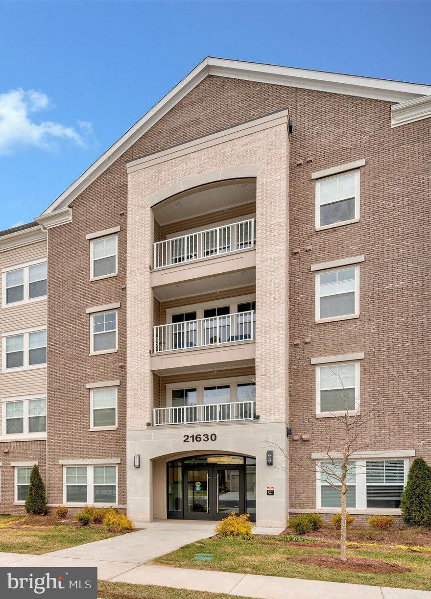 This is the one you've been waiting for! Almost new, lightly lived-in condo in Del Webb's premier over-55 community, Montebello. The community is fully built-out, offering you a "better than new" condo with all upgrades already completed—it truly resembles a model home. Largest floor plan with over 1900 square feet, three bedrooms, and parking for three cars. The meticulous owners have enhanced this spacious condo with board and batten wainscoting in the entry hallway and dining room, custom paint throughout, designer drapes and blinds, upgraded herringbone ceramic tile backsplash, modern light fixtures, patio retractable screen door and sunshade, and primary closet built-ins. The kitchen-adjacent office nook features custom built-in storage, functioning as an elegant butler's pantry for storing and displaying fine china and doubling as a fun cocktail bar for entertaining!. This light-filled corner unit offers durable LVP flooring throughout main living areas and premium carpet in the bedrooms. The open floor plan includes: *Spacious dining room and living room with abundant windows *Open-concept kitchen featuring breakfast bar, white shaker soft-close cabinets, quartz countertops, KitchenAid stainless steel appliances, pantry closet, and custom tile backsplash *Inviting corner balcony, perfect for morning coffee or evening relaxation *Laundry room with dual washer/dryer and storage cabinets *Primary bedroom with tray ceiling, king-sized bed capacity, and large walk-in closet *Second and third bedrooms positioned away from the primary for privacy, with access to the full second bathroom. Downsizing doesn't mean compromising on space in this generous condo! Conveniently located near the building stairs for easy access—ideal for dog owners or those frequently coming and going. The unit includes a deeded garage with epoxy flake flooring, accessible through the lobby. Park a second vehicle on the pad outside the garage door, with a third dedicated parking space steps from the front door, plus additional visitor parking nearby. A lobby-level storage cage is also included. The building backs to the pond with the clubhouse just a short walk away. Montebello offers comprehensive amenities: indoor and outdoor pools, fitness center, clubs, activities, and walking trails. Conveniently located for commuting via Routes 7, 28, 50 and the Dulles Toll Road, close to shopping (Costco nearby!), restaurants, and adjacent to beautiful Claude Moore Park. Hurry—this one won't wait!