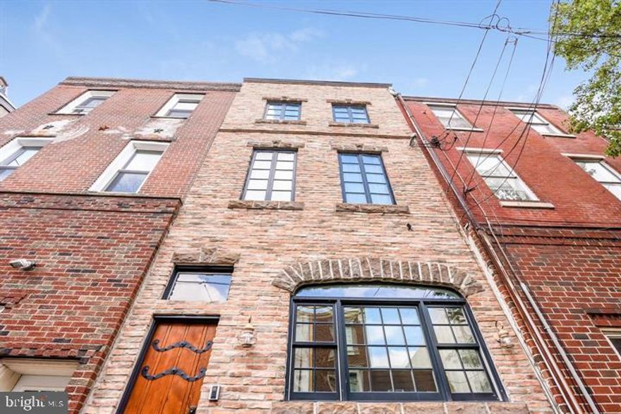 Stunning custom built home with separate carriage house with studio and  1 CAR GARAGE. This European inspired 4 bedroom 2.5 bath home features a antique brick and cut stone facade, custom front door, wide plank Cypress wood floors T/O, Rumsford fireplace with wood mantle and handmade tiles, gourmet cook's kitchen with stainless appliances, honed granite counters and a farm house sink. Special features include hydronic radiant heated floors (main floor and baths), 3 zone high efficiency HVAC, a bilevel roof deck with garden, built in seating and automatic drip irrigation, wireless security system with camera, in ceiling speakers T/O including roof deck. There's a full basement with tons of storage and large laundry area with full size washer/dryer. Current family room could be 4th bedroom with large closet. Carriage house with a(with separately metered 100 AMP service and water) studio has a full bath and sleeping loft. The studio is not heated or cooled. This is a very special home and not to be missed. Close to all the wonderful things that we love about city living including some of the best pizza in all of Philly!!!!