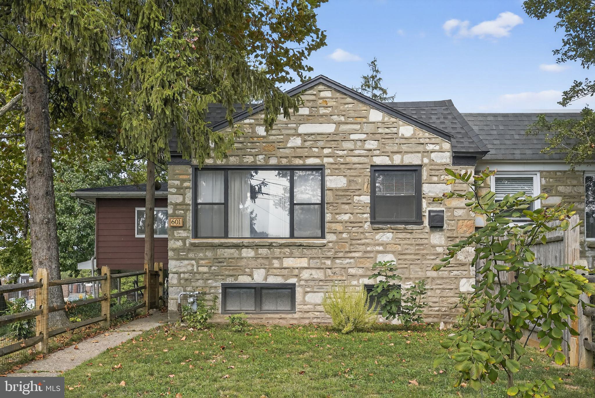Welcome to 601 Calamia Drive, a lovingly maintained home nestled on one of the largest corner lots in this quiet Norristown neighborhood. Whether you’re moving up or buying your first place, this one checks all the boxes—and then some.
Let’s start with the curb appeal. Sitting proudly on a generous lot with mature trees and a serene backyard, this home features a long driveway that comfortably parks 5–6 cars, a carport, and a one-car garage for added storage or workshop potential.
Inside, the natural light is immediate and abundant, shining off the warm hardwood floors throughout the main level. The updated kitchen boasts stainless steel dishwasher and refrigerator and new LVP flooring, giving it a modern yet timeless feel—ideal for everyday meals or weekend hosting.
Upstairs, you’ll find three comfortable bedrooms, while the real surprise is the spacious 300 sq ft primary bedroom addition complete with new carpet (2024), heat venting, and plenty of layout flexibility.
The full bathroom has just been updated with new tile flooring (2025), and there’s also a stylish renovated powder room in the basement, along with a walk-in closet for even more storage.
The finished basement adds serious bonus space—think rec room, gaming zone, home gym, music room, or office—with LVP flooring (2022) and a clean, modern feel. It’s functional and flexible, just like the rest of this home.
Other highlights: New roof (2022) – with both shingle and silver coat finishes. Furnace and water heater (2016) – well-maintained and efficient. GE washer/dryer (2020) – included and ready to go. No central AC, but home is ducted for a future system—simple condenser upgrade. One of the biggest backyards in the neighborhood—perfect for gatherings, gardening, or simply relaxing under the trees.
What sets this home apart is the care and craftsmanship the previous owner put into it. Move-in ready, no projects needed—just bring your furniture and settle in. Minutes from King of Prussia, major commuting routes, and shopping, 601 Calamia offers the space, charm, and flexibility today’s buyers crave. Don’t miss this rare opportunity to own a solid, thoughtfully upgraded home on a standout lot. Schedule your showing today!