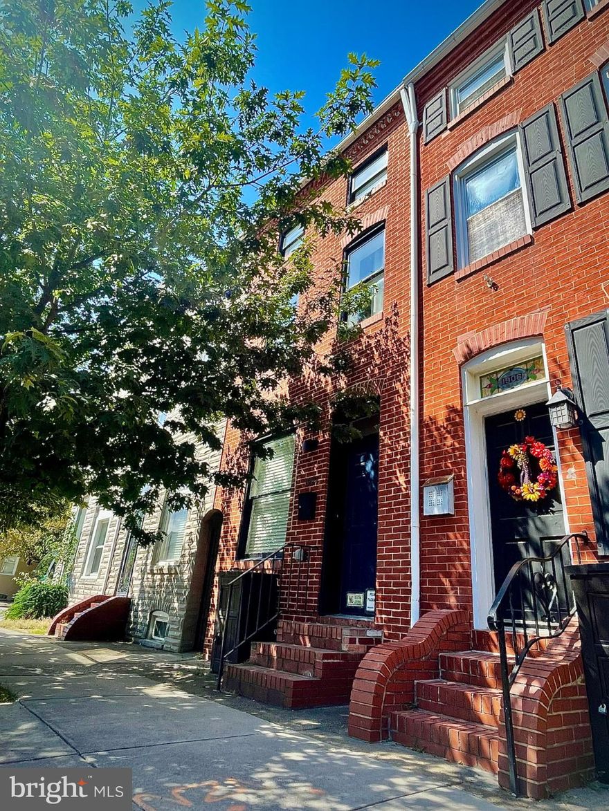This three-bedroom, three-and-a-half bath rowhome offers nearly eighteen hundred square feet across three levels, designed for both ease and character. Exposed brick walls line the living spaces—warm and textured, a reminder of the city’s past woven into modern finishes. Natural light falls in from tall windows, carrying across hardwood floors and into an open main level that flows seamlessly. Each bedroom is paired with its own full bath, a rare feature that gives every resident or guest a sense of privacy. A full-sized washer and dryer are included, and the home culminates in a private roof-top deck with sweeping views of Baltimore’s skyline.

Beyond the front door, the neighborhood unfolds effortlessly. Less than a block away, Little Donna’s earns national acclaim, while Water for Chocolate, Ekiben, Marta Fine Food & Spirits, and Johnny Rad’s offer standout dining nearby. To the east, within a short walk, Patterson Park stretches wide with green fields and shaded paths. Heading south, Thames Street winds along the waterfront, lined with Fells Point landmarks—Kooper’s Tavern, Sláinte Irish Pub, The Daily Grind, Thames Street Oyster House, and The Admiral’s Cup with its live music—passing the post office on the way. Just north, Johns Hopkins is close enough to walk, yet only a couple minutes by car. To the west, a very short drive brings you to Little Italy, where a cluster of celebrated restaurants and cafés includes the beloved Vaccaro’s Italian Pastry Shop. For daily errands, Safeway is only a few minutes’ drive toward Canton, and just beyond, Canton Crossing gathers Harris Teeter, Target, Crunch Fitness, and a lively mix of shops and restaurants. From every side, the essentials of city life are close at hand, paired with some of Baltimore’s most iconic dining and cultural destinations.

1904 Bank Street blends space, history, and convenience—a home rooted in Baltimore’s character, surrounded by the best the city has to offer.