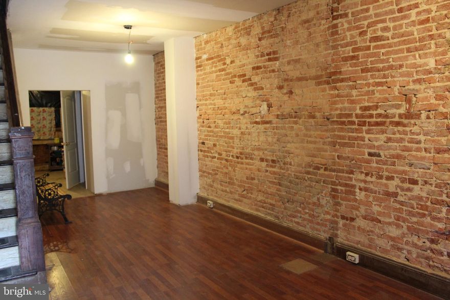 INVESTOR  OR HANDYMAN ALERT! Motivated Seller.  Bring all offers!!  Don't miss this opportunity to buy a good house in a great location close to Johns Hopkins hospitals and school of medicine.  Buy and flip or buy and hold.   Most of the work has been completed on this property.  Upper level tile floors throughout.  Fully renovated full bathroom.  Main level wood floors, beautiful exposed brick and open floor concept.  All electrical and plumbing work has been completed.  Add your finishing touches and make this home yours.  Additional crown molding and finishes to be finished within a week.  Schedule your showing today!