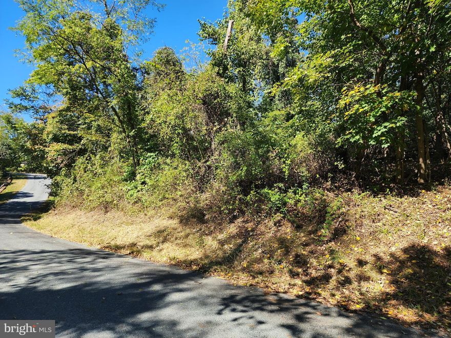 Great location for a home. This is .96 acres and has plenty of room to position your home. It is perc approved for a Sandmound septic system, a septic permit was issued but has expired, just has to be renewed.  A well is needed. Lots of mature trees. The lots on the other side of the road are very sloped and more than likely can not be built on. Carroll Valley has a few public parks  and lakes to enjoy. Bring your own builder. No HOA . This lot is very close to Liberty Mountain Ski/Golf Resort. The Hisoric Gettysburg Battle Field is only about 12 miles away.