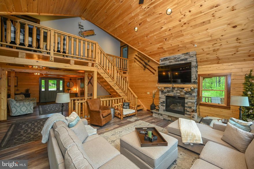 This “Lil Slice of Heaven” is a masterfully designed 5-bedroom, 4.5-bath cedar retreat along Hole #7 of Lodestone Golf Course, offering privacy, luxury, and stunning views in one of Deep Creek’s most desirable locations. Crafted from premium cedar, this home stands apart for its natural durability, warmth, and timeless appeal — superior to standard pine. Inside, the open layout features vaulted ceilings, a stone fireplace, and Amish-crafted furnishings. The kitchen is a chef’s dream! Appointed with granite counters, custom cabinetry, and a gas range, perfect for everything from casual meals to entertaining. Five spacious bedrooms include a main-level suite with deck access and two upper-level suites with private balconies. The lower level offers a large family room with pool table, wet bar, and media area. Step outside to an expansive deck and beautifully landscaped backyard oasis, complete with a private hot tub, built-in grill, outdoor fireplace, and cozy firepit area — ideal for relaxing under the stars. An electric car charger adds a modern touch of convenience. Just minutes from Deep Creek Lake, Wisp Resort, and local shops and dining, this home offers both an incredible lifestyle and strong rental potential. Whether full-time or part-time, A Lil Slice of Heaven truly lives up to its name.