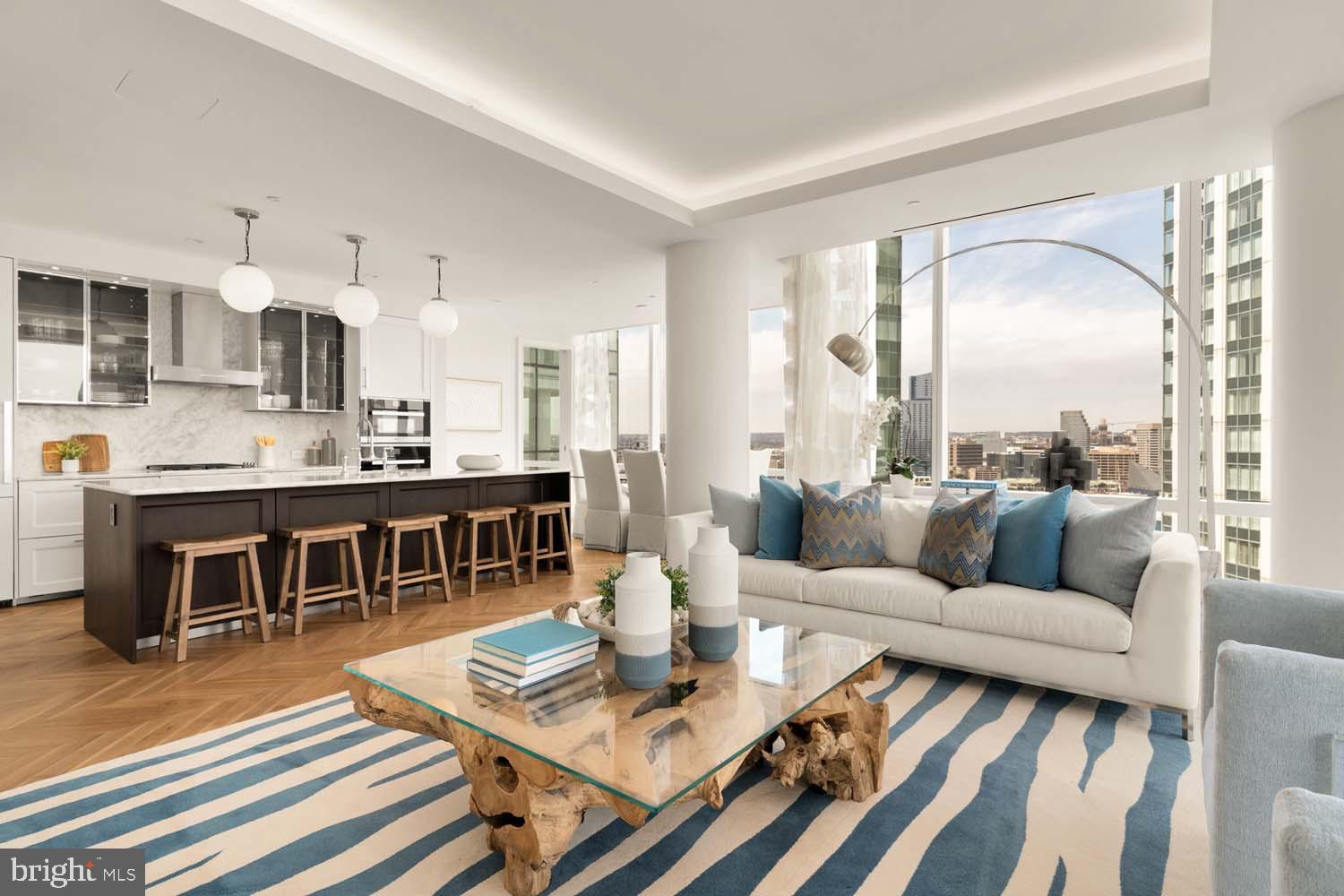 INCENTIVIZED PRICING - JUST REDUCED FROM $1,500,000!! BRAND NEW TWO-BEDROOM CORNER UNIT WITH BALCONY AVAILABLE!
Welcome to the Four Seasons Private Residences in Harbor East, where luxury meets lifestyle in Baltimore’s most coveted waterfront address. Perched above the city in a prime corner location, this exceptional two-bedroom, two-bathroom residence offers breathtaking views of the Inner Harbor and sweeping city skyline from nearly every room. With floor-to-ceiling windows that bathe the home with natural light, and a private balcony, the ever-changing waterfront scenery becomes part of your daily living experience. Thoughtfully designed to utilize every inch with purpose, this unit lives larger than 1,685 sq ft! Step into an atmosphere of sophistication with soaring ceilings, rich walnut chevron-patterned flooring, and designer finishes throughout. The gourmet kitchen is a chef’s dream, outfitted with Miele appliances, sleek Eggersmann soft-close cabinetry, luxurious marble stone countertops, and a built-in Sub-Zero wine fridge - perfectly blending timeless elegance with modern function. The primary suite is a tranquil sanctuary, offering two custom-built walk-in closets for optimal storage and a spa-inspired, marble-clad en-suite bath featuring a double vanity with designer finishes, a glass-enclosed walk-in shower with a built-in bench and niche, separate water closet, and a sculptural freestanding soaking tub that invites total relaxation. The second bedroom offers equal comfort and privacy with its own full bath and ample storage. Every inch of this home is elevated by exceptional attention to detail, all complimented by an absolutely breathtaking waterfront backdrop.
The Four Seasons Private Residences Baltimore offers a turn-key elevated lifestyle. As a resident, you'll enjoy a private entrance where you will be met by our full service concierge and on-site building manager to assist with your every need, as well as exclusive access to the sprawling 28th-floor amenity level, where world-class services meet resort-style indulgence. Amenities include an indoor heated saltwater infinity-edge pool, a state-of-the-art fitness center, sauna, coffee station, billiard room, and numerous elegant gathering spaces. Multiple rooftop decks offer panoramic city and harbor views, complete with indoor and outdoor fireplaces, a grilling station, a dining area, and a kitchen, all ideal for entertaining. Completing this unparalleled lifestyle experience are a fully equipped conference room and a dedicated AstroTurf dog-walking area. This residence offers the rare opportunity to live within a full-service, hotel-branded building while enjoying the privacy and sophistication of a true luxury home. All set within steps of Harbor East’s acclaimed restaurants, shopping, and the waterfront promenade. This is a MUST SEE TWO BEDROOM!! Immediate occupancy is available. Come see what all the fuss is about!
*Photos are from a model of the same exact floor plan*