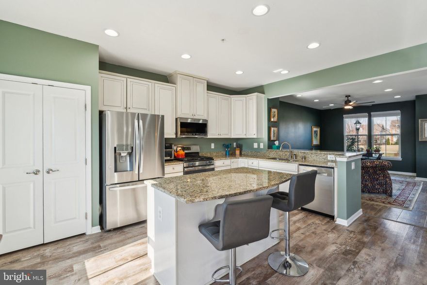 Welcome to your new home in the sought-after Brunswick Crossing community, this stunning Neo-traditional townhome with a detached two-car garage boasts over 2,300 square feet of beautifully finished living space, full enclosed backyard and located across a huge community courtyard! Perfectly positioned across from a spacious courtyard and playground, this home radiates pride of ownership and offers an inviting atmosphere for both everyday living and entertaining.
Step inside to discover a bright and thoughtfully designed open-concept layout. The heart of the home, the kitchen, is equipped with stainless steel appliances, granite countertops, recessed lighting, a pantry, ample storage, and a functional center island. Adjacent to the kitchen, the dining area showcases rich hardwood floors and French doors that bathe the space in natural light while leading to the Trex deck, complete with vinyl railings. A convenient half bath and coat closet complete this level.

Upstairs, the expansive primary suite offers a walk-in closet and a private en-suite bathroom featuring ceramic tile, dual vanities, and a spacious shower. Two additional bedrooms, a second full bath, and a dedicated laundry area ensure comfort and convenience for all.

The lower level provides additional living space, including a versatile den perfect for a home office, gym, or study, with the potential to add a full bathroom. A generously sized recreational room offers direct access to the fenced and low maintenance back yard, leading to the oversized detached two-car garage—ideal for effortless outdoor living and storage.

Living in Brunswick Crossing means access to an array of exceptional amenities, including a large community pool, sand volleyball court, sports fields, a playground, fire pit area, and scenic walking trails. Indoor facilities feature a fitness center, yoga studio, library, and a spacious community center perfect for hosting gatherings.

Conveniently located just minutes from the historic Brunswick District along the Potomac River and C&O Canal, this home is a commuter’s dream. The nearby Brunswick MARC station provides easy access to Montgomery County and Washington, D.C., while an array of shopping, dining, and retail options are just moments away.

Don’t miss your opportunity to own this exceptional home!