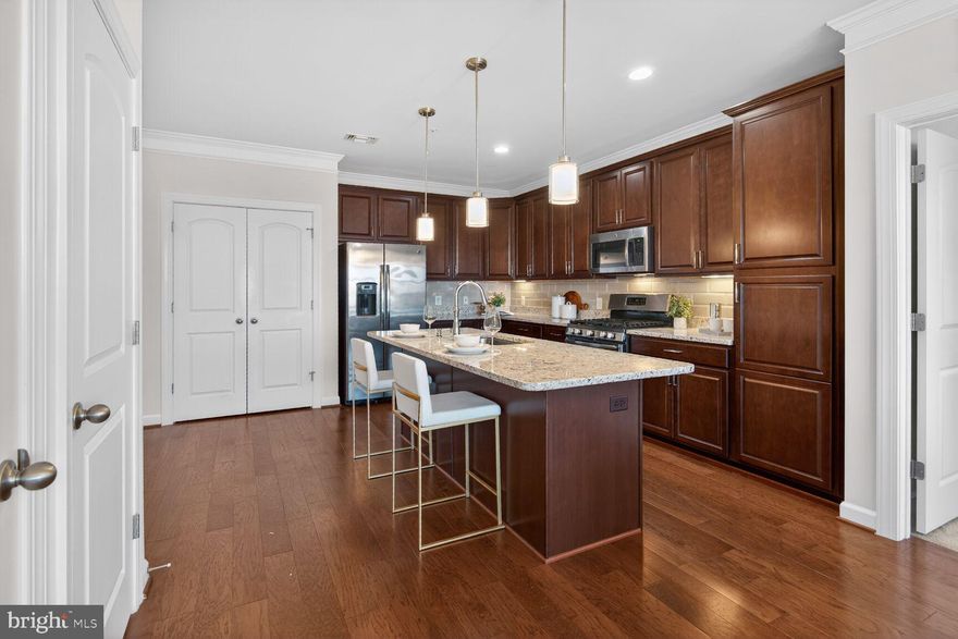 *Professional photos & virtual tour comings soon* The best of Herndon awaits in this updated, move-in ready 2 bedroom/2 bath condo. Park your car in the garage (assigned parking & no snow shoveling!) and live the dream of home ownership. As you enter, you’ll love the bright light from the oversized windows, open concept and beautiful hardwood floors. The home includes a living room, dining area, gourmet kitchen, 2 bedrooms, 2 bathrooms and a balcony. The kitchen is a dream come true for cooking and entertaining guests with wood cabinets, granite counters, oversized island, porcelain tile backsplash, stainless steel appliances, pantry and new lighting. The living room and dining combo is perfect for hosting dinner parties or binging your favorite show. The primary bedroom has 2 big closets and an ensuite bathroom with double vanities. The second bedroom is equally large and also has 2 closets. The home includes an in-unit washer and dryer, an oversized coat/storage closet along with an incredible patio – just right for dining al fresco or sipping your morning coffee. Along with all the bells and whistles of this home, you’ll have quick access to shopping, biking, Dulles Airport, major roads and the quaint town of Herndon