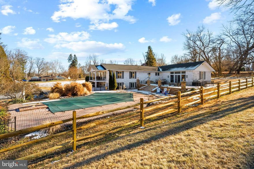 Welcome home to this spacious and inviting residence in the sought after Honeysuckle Hill community in Glen Arm.  With over 3,000 square feet of finished living space, a private in ground pool, and flexible room options for today's lifestyles. This 4-to-5-bedroom, 5 bath home offers the perfect blend of comfort, functionality and timeless appeal. The main level features an inviting living room and family room, each with its own double sided wood burning fireplace, creating warm and welcoming spaces to gather. The gourmet kitchen is a chef's dream, showcasing granite countertops, stainless steel appliances, a center island, double wall ovens, and abundant counter and cabinet space. Luxury vinyl plank flooring flows throughout the main and lower levels adding style and durability. The spacious primary suite offers vaulted ceilings, and a beautifully updated ensuite bath complete with soaking tub, walk in shower, and double sink vanity. Sliding glass doors from the primary bedroom open to a private flagstone patio. Two bedrooms also include ensuite bathrooms, and one bedroom offers a walk out private balcony.  The fully finished lower level is an entertainer's dream, offering a large recreation room, wood burning fireplace and a bonus room that could be used for your office or as a 5th bedroom. This level provides endless possibilities for entertaining, guest space, or added living space. Step outside to your private outdoor oasis, featuring an in-ground pool, extensive hardscaping, flagstone patio, and beautifully landscaped with fenced grounds on 1.33 acres. This exceptional home combines space, upgrades, and resort style outdoor living truly a rare find.