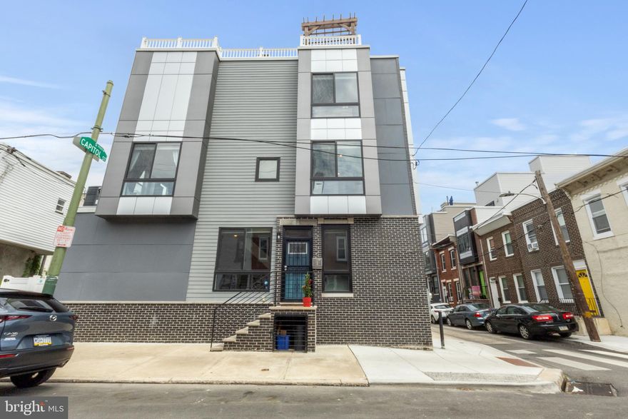 CORNER LOT!  TONS OF NATURAL LIGHT!  4.5 YEARS LEFT ON THE FULL TAX ABATEMENT! 
Welcome to 1556 S Capitol Street — a beautiful new construction home located in the highly sought-after neighborhood of Point Breeze. This spacious, open-concept property offers 4 bedrooms and 3 full bathrooms. On the main floor, the bright living room flows seamlessly into the dining area and a stylish kitchen featuring stainless steel appliances, quartz countertops, and custom cabinetry. The finished basement has multiple closets, perfect for your storage needs, and a full bathroom. On the second level, you'll find two well-sized bedrooms that share a full hall bathroom. On the third floor, the primary bedroom is a true retreat. The master bath is equipped with a dual vanity and a dual head, walk-in shower. This floor also boasts a wet bar area, perfect for hosting on your private rooftop deck. Enjoy skyline views under the custom-built pergola! The roof deck has been recently (2024) resealed so you have no maintenance worries! Additional highlights include hardwood floors throughout, recessed lighting, central air, custom blinds, security system, and a built-in speaker system in living room, primary bedroom, and roof deck.
This exceptional home combines modern luxury, a fantastic layout, and a prime location in Point Breeze. Just a few blocks away from the house, the seasonal Community Market occurs weekly. Great breweries, restaurants, and parks are within walking distance – Dock Street, Sardine Bar, Madira, El Mezcal, Two Eagles Café, Porco’s, Second District Brewing…the list goes on. Centrally located, the house has easy access to East Passyunk, Center city, Graduate Hospital, University City, and I 76. With 4.5 years left on the tax abatement - Don’t miss the opportunity to make it yours!