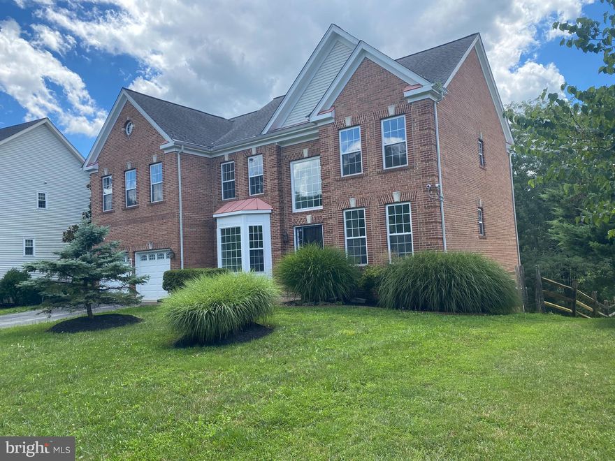 Welcome to 2773 Millers Way Drive.  This traditional style brick-front home boasts almost 5,000 sq ft of finished living space and encompasses 6 total bedrooms and 3 ½ baths. As you walk up the driveway you are greeted by a 2-car garage and lovely landscaped front yard including plush green grasses.  Stepping into the two-story foyer, you'll be amazed with plenty of natural light.  Hardwood floors throughout the main level. The expansive kitchen includes a double-oven, built-in microwave, gas range island cooktop, a stainless-steel refrigerator, and dishwasher with plenty of cabinet space.  The two-story family room is of considerable size with a fireplace leading to a step-down sunroom.
On the upper level, you will find four bedrooms. The primary bathroom includes a soaking tub. 
Partially finished, large lower-level includes a generous rec room, 2 additional bedrooms and an unfinished area for additional storage.   
Outside you will find a fenced generous-sized backyard,  with a concrete patio to enjoy the upcoming fall nights.  The exterior spiral staircase provides additional access to the backyard from the sunroom on the main level. This beautiful home will not last! Make it yours today!
