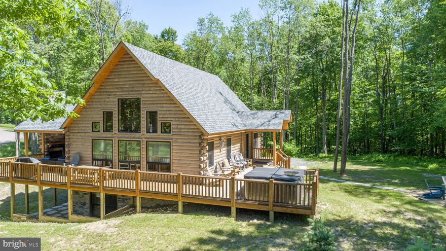 Modern Rustic Dream Come True - This gorgeous log home built by Cedar Ridge Log Homes was perfectly designed for living the mountain lifestyle.  It is a retreat that perfectly blends contemporary design and natural charm . It is bright and open throughout with elegant modern finishes. Plan to cozy up by the fireplace in the great room after a day on Wisp Resort ski slopes.  A spacious primary suite upstairs allows for privacy. The family room and pool table downstairs will help make sure everyone is entertained. The wrap around deck and covered outdoor fireplace give you a perfect gathering place. Bordering Fork Run Recreation Area you have acres of hiking and biking trails right at your fingertips. Embrace mountain living at its finest in this meticulously crafted home that harmonizes modern luxury and rustic allure.