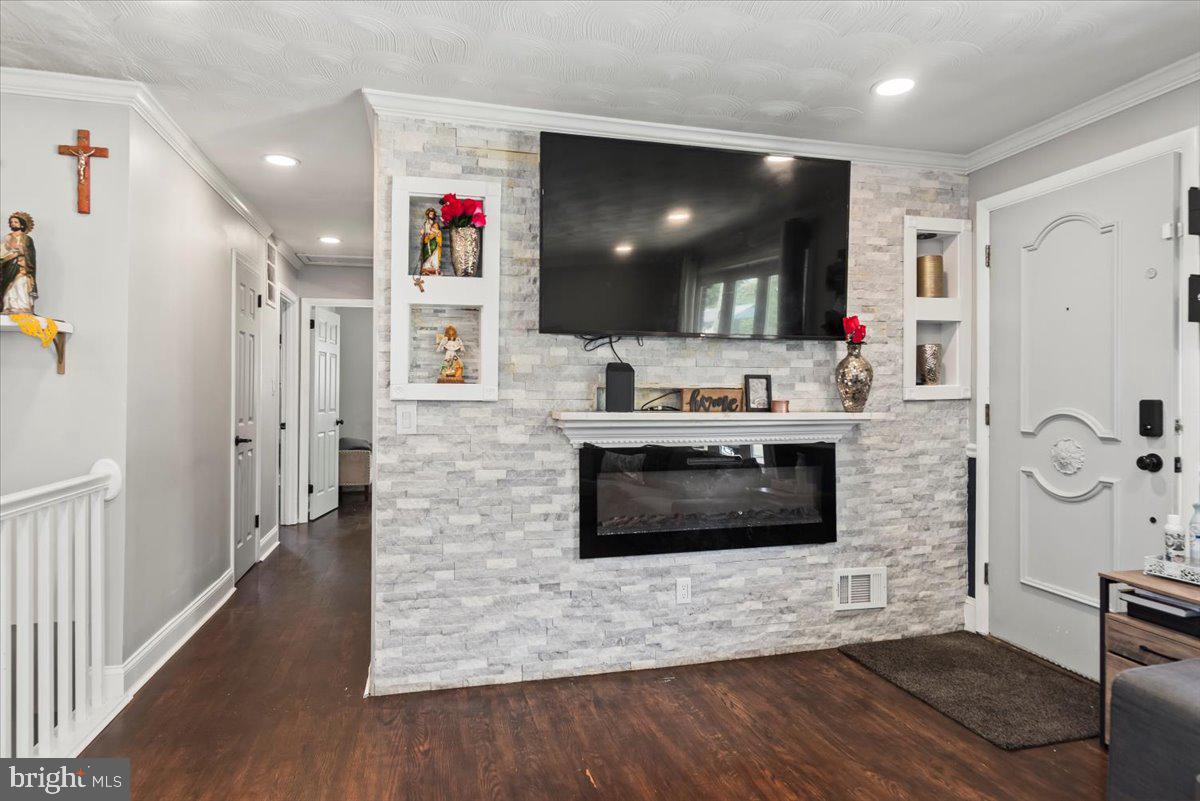 $10,000 PRICE REDUCTION!
Hurry! Check Out This Beautiful Brick Cape Cod in Pepper Mill Village!
Welcome to one of the finest brick rancher-style homes in the sought-after Pepper Mill Village community! This well-maintained gem offers a spacious open-concept entry, blending modern style with classic charm.
* Main Living Areas
Step into a warm and inviting living room, featuring a striking grey sparkle brick accent wall and in-mount electric fireplace. Recessed lighting throughout enhances the sleek, modern ambiance, while hardwood floors flow seamlessly across the main level.
* Gourmet Kitchen
The kitchen boasts quartz countertops, white cabinetry, black & stainless-steel appliances, gas stove, and pendant lighting—perfect for everyday meals or entertaining.
* Bedrooms & Baths
The entry level includes two generously sized secondary bedrooms; a full bathroom and the primary bedroom has a private en-suite.
* Bonus Family/Patio Room
Enjoy year-round comfort in the 264 sq ft enclosed patio/family room, featuring a ductless mini-split system, a second full kitchen with electric stove, and a built-in club bar for entertaining or relaxing. Expansive windows flood the space with natural light, and dual entry doors provide access to the carport and backyard.
* Mudroom & Finished Basement
Downstairs, discover a fully finished basement with elegant grey ceramic tile flooring, colored lighting above crown molding for a party vibe, a 3rd full bathroom, and a large room that serves perfectly as a 4th bedroom. Access the basement via stairs from the patio/family room area or from the main level kitchen.
* Outdoor Living
The backyard includes a built-in brick barbecue pit, ideal for cookouts and family gatherings. A covered 3-car carport and wide street parking add exceptional convenience.
* Location & Accessibility
Perfectly located near Central Ave, X9 Bus Route, and major commuter routes including I-495/95 and Route 50, this home offers both comfort and connectivity.