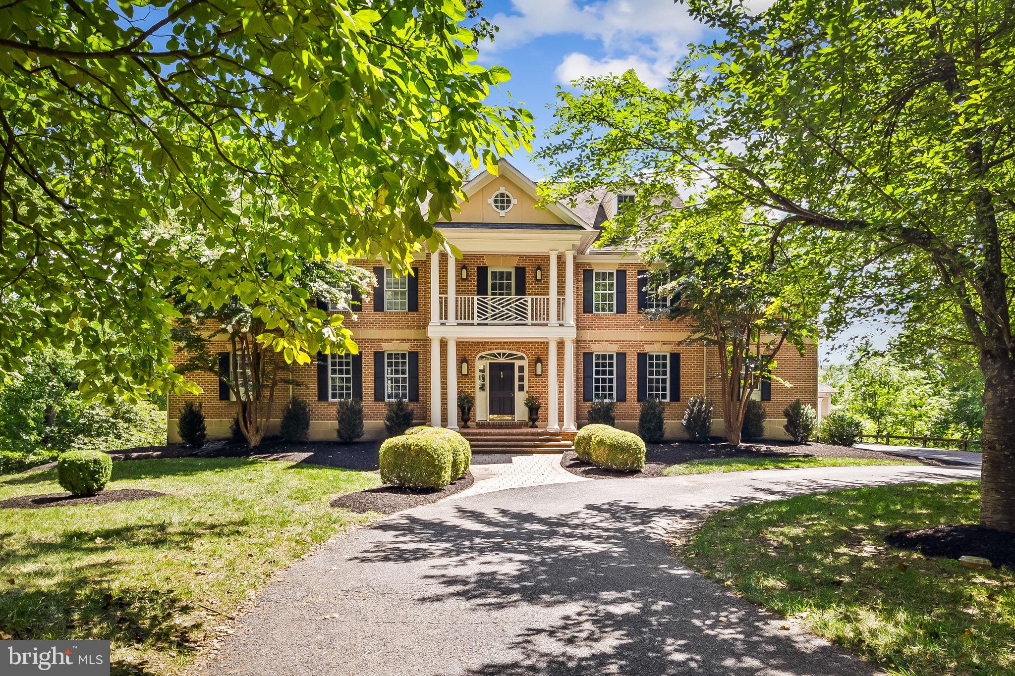 Tucked away adjacent to Eagle’s Nest Country Club, 12829 Stone Eagle Road is a splendid all-brick Colonial home in the Eagle’s Nest Estates community offering the perfect blend of suburban surroundings and urban accessibility. The home spans four finished levels and features seven bedrooms, five full baths, and two half baths. The layout and space can accommodate various living arrangements. Step into the grand two-story foyer that opens to a bright, contemporary interior, adorned with detailed millwork, including wainscoting, crown molding, and built-in bookshelves. Hardwood flooring, recessed lighting, and soaring 9+ foot ceilings add to the home's elegance. Five fireplaces offer warmth and sophistication throughout. The main level boasts a formal dining room, living room, and a sizable family room that opens to an expansive rear deck. The gourmet kitchen is a chef’s dream, featuring high-end appliances, white shaker-style cabinetry, white quartz countertops, and white subway tile backsplash. The eat-in kitchen layout seamlessly flows into the versatile bonus space, ideal for a TV room, playroom, or study area. Additional highlights on this level include a private office, a large sunroom, and two half-baths. Ascend to the second-level hall, where a wraparound banister overlooks the grand foyer. The primary suite is a true retreat with a cozy fireplace, a separate sitting room, two dressing rooms, and a luxury bath. Three bedrooms, two full baths, and a convenient laundry room finish this level. Providing comfort and space, two more bedrooms and a full bath are located on the top level. The walk-out lower level is complete with entertainment options, including a recreation room with a fireplace, a media room, and a fitness room equipped with rubber gym flooring. The home’s seventh bedroom and a full bath make hosting overnight guests a breeze. Enjoy elevated views from the rear deck and notice the peaceful atmosphere the mature trees generate around the home. The attached garage and a separate detached garage accommodate four cars and offer additional storage space. With its prime location in Baltimore County, the community is a short drive to shopping centers, restaurants, entertainment, and commuter routes. Minutes away from Loch Raven Reservoir, outdoor enthusiasts will appreciate hiking, rowing, paddle boating, bird watching, horseback riding, hunting, and fishing. Schedule your visit today to view this home with desirable features inside and out.