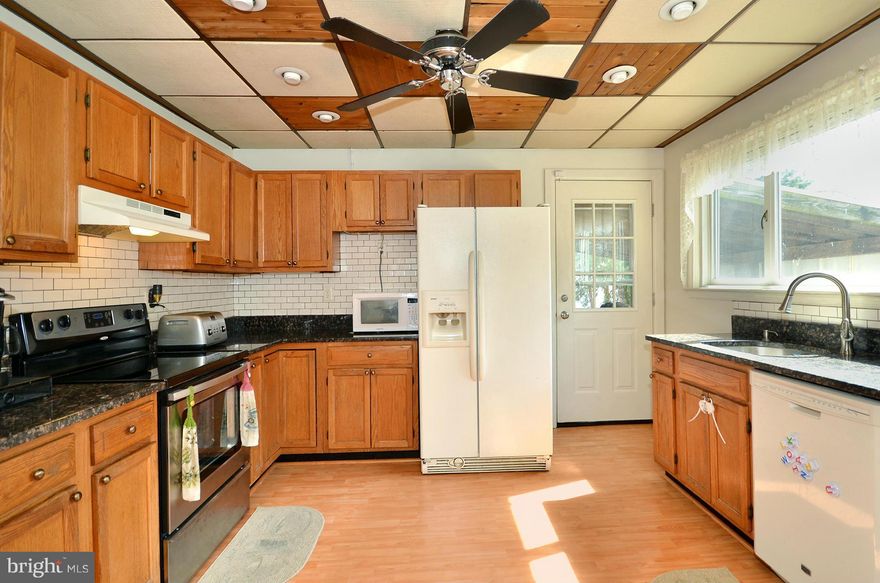 Don't miss the opportunity to own this wonderful starter home! 5 bedrooms w/ the potential for 6... 2 full baths, finished lower level & pellet stove,OVER 2,500 FINISHED SQFT!! flat backyard, ample parking, & easy access to 695 & I-95. Central AC, updated Heat Pump, newer hot water heater, granite counter-tops, new stove,new washer..1 YEAR HOME WARRANTY!*Shed sold AS-IS*