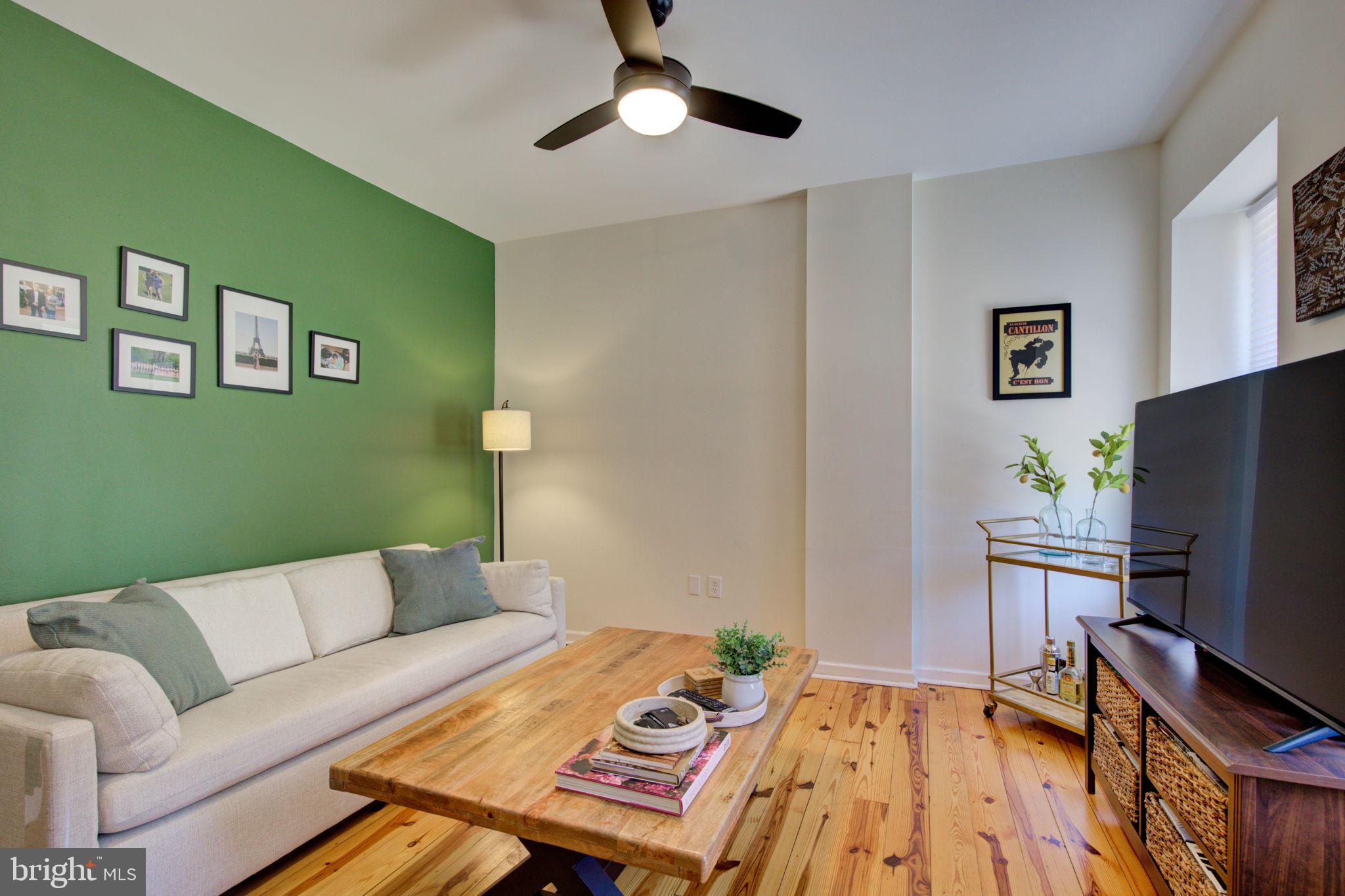 Welcome to this beautifully updated end-unit rowhome in the heart of Manayunk! Blending modern updates with classic charm, this spacious home offers three levels of comfortable living. The first floor features a bright living room and an updated kitchen that opens to a private deck, perfect for outdoor dining and entertaining. From the deck, step down into the large yard—a rare find in Manayunk. Upstairs, the second floor boasts a generously sized primary bedroom, a full bathroom, and a flexible laundry room/office space. The third floor offers two additional spacious rooms, one complete with a dry bar and custom-built entertainment center - ideal for hosting, relaxing, or guest suite. Additional highlights include beautifully refinished original hardwood floors throughout, full basement for storage, and a prime location within short distance to some of Manayunk's favorite eateries, shops, and nightlife. Tastefully updated throughout, this home combines style, functionality, and outdoor living - all just minutes from public transportation and all that Main Street has to offer!