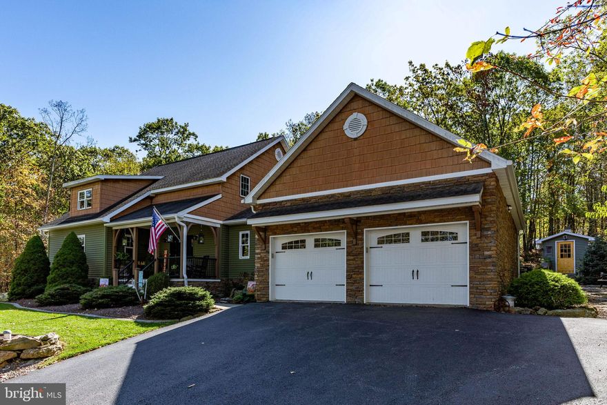 Discover the ultimate retreat in this exquisite property, where every detail has been thoughtfully curated to blend rustic elegance with modern luxury. Located in Eagle Rock Resort, this 3-bedroom 3-bathroom home has been meticulously maintained. Nestled in a serene natural setting. The property backs up to the Arnold Palmer designed golf course on 7th fairway. Enjoy course views and yet

privacy still maintained. The main floor primary bedroom suite boasts a spacious walk-in closet. The ensuite bathroom has a stylish walk-in shower. First floor laundry room makes this home perfect for those looking for main level living!
Step into the welcoming entryway, where warm tones and inviting tile flooring sets the stage for the comfortable elegance found throughout. The heart of the home is an impressive open concept living area, featuring a breathtaking gourmet kitchen and an adjacent dining space. The kitchen boasts soaring vaulted wooden ceilings with exposed beams, light white/beige cabinetry, gleaming stainless-steel appliances, and generous granite countertops. A functional breakfast bar with seating provides ideal spaces for meal prep and casual dining. The connected dining area, is perfect for memorable meals. This home has radiant heating throughout to keep you cozy warm in the winter months. All doors in the home are gorgeous Alder wood.
Elegant sliding barn doors lead to a luminous sunroom, a true oasis bathed in natural light from expansive windows that offer picturesque views of the surrounding landscape. With its vaulted wooden ceiling, this versatile space is perfect for relaxation, reading, or enjoying the tranquility of nature. Exit through the door to beautiful deck.
The inviting living room centers around a magnificent, floor-to-ceiling stone fireplace, providing a cozy ambiance on cooler evenings. Rich wooden floors throughout the home, and large windows create a warm and welcoming atmosphere.
Upstairs, a spacious loft area overlooks the living room and kitchen, offering a versatile space ideal for a home office, den, or additional family room. With its matching vaulted wooden ceiling and comfortable seating area, it is a serene hideaway with inspiring views. There are two bedrooms and a full bathroom on this level.
The partially finished basement includes two extra rooms that can function as an office, recreational area, or guest rooms. Home also has a generator.
The expansive grounds feature multiple areas for enjoyment: a picturesque firepit area under a second, larger pergola, ideal for evening gatherings under the stars. Here, you will be serenaded by the gentle sounds of your very own natural stone waterfall, cascading beautifully into a lush, fern-lined landscape - a true focal point for peace and tranquility. Explore well-maintained paths leading to a delightful storage shed with charming yellow accents, and a dedicated wood storage shed. Lush landscaping, natural stone, and a serene woodland backdrop create an idyllic setting for privacy and outdoor recreation.
This property is more than just a home; it is a lifestyle escape, offering unparalleled comfort, stunning design, and exceptional outdoor living spaces.
Eagle Rock Resort features year-round amenities, including an 18-hole Arnold Palmer golf course and a 9-hole executive course, dining/bar at the clubhouse, three heated outdoor pools, and an indoor complex with three additional pools and hot tub. Facilities also include an equestrian center for horseback riding and boarding, activity center, fitness center, saunas, full-service spa, and courts for bocce ball, tennis, pickleball, volleyball, basketball and cornhole. In the winter months there are opportunities to snow tube and ski. The community and the resort also plan social events throughout the year for entertainment.
The home is situated near the main gate, providing straightforward entry and exit.
Measurements are provided as estimates.