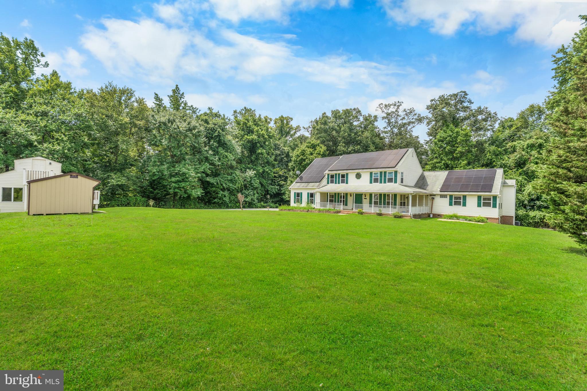 Nestled on a pristine acre of meticulously maintained level terrain, this distinguished five-bedroom, four-and-a-half-bathroom sanctuary epitomizes refined country living with contemporary conveniences. This architectural gem spans over 5,000 square feet of thoughtfully designed living space, featuring not one but two primary suites that offer unparalleled comfort and privacy.
The residence welcomes you with a charming wrap-around porch that beckons leisurely evenings. Step inside to discover gleaming hardwood floors that flow throughout the main level, complemented by a dramatic two-story family room crowned with a welcoming fireplace. The finished walk-out basement expands your entertainment possibilities while maintaining seamless indoor-outdoor connectivity.
Practical luxury abounds with dual primary suites, including a main-level in-law suite complete with its own kitchen, laundry, bath and skylights that bathe the space in natural light. The property's automotive accommodations are equally impressive, featuring a two-car attached garage, and an expansive driveway capable of hosting gatherings with ease.
The fully gated grounds offer complete privacy while providing ample storage with two sheds, and a distinctive carriage house. This remarkable property presents exceptional renovation potential for the discerning buyer seeking to customize their dream estate. Located within proximity to Clearwater Nature Center, residents enjoy easy access to outdoor recreation and natural beauty, making this an ideal retreat for those who appreciate both solitude and convenience in equal measure. This home is a must see. Schedule your appointment today.