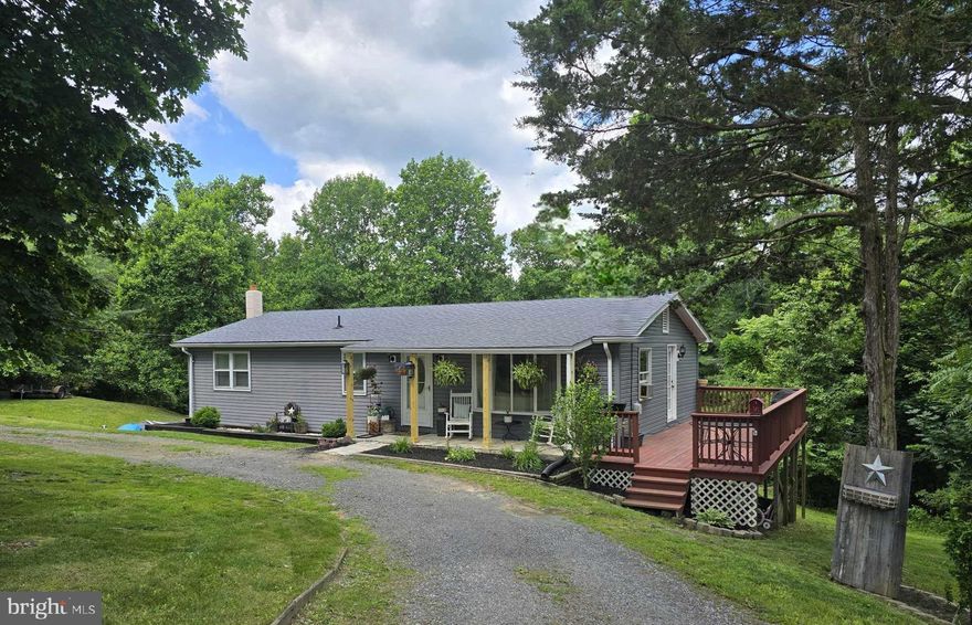 Absolutely charming Ranch home featuring 3 bedrooms and 1 1/2 baths, galley style kitchen with adjoining dining area as well as a full, unfinished, walk-out basement with laundry area and woodstove.  (The woodstove has been hooked into duct work providing efficient heat for those chilly winter months.)  Luxury vinyl plank flooring throughout the home, as well as chair rail molding and crown molding in various rooms provide a tiny of bit grandeur to this adorable home.  The residence is situated on 1.29 acres, and is just less than a mile from downtown Berkeley Springs, WV (Town of Bath) with all of it's charming shops/spas/restaurants.