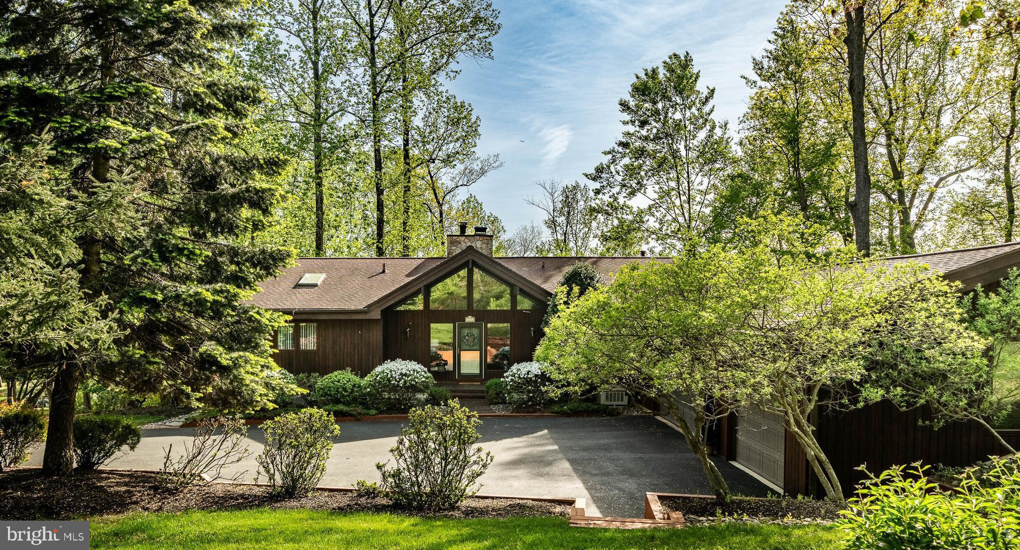 Welcome to this magnificent custom Lindal Cedar Home with privacy and features that are sure to amaze you. Located In the award-winning Garnet Valley School District and in the prestigious Highlands development. 12 Bonnie Lane was built in 1997 with architectural details and materials provided by the premier Lindal Cedar Home Company designers. The 4,130 sq ft post and beam construction with vaulted ceilings and views of the manicured yard from the floor to ceiling windows is breath taking. Proceed along the private, tree-lined driveway to the three-car garage or enter through the grand entrance into the foyer. The sun-drenched Great Room features a stone gas fireplace, custom wet bar and views of the rear yard. To the right, you will find the kitchen featuring a fireplace, maple cabinets, a center island with a gas cooktop, granite counter tops and so much more. Enjoy daily meals in your Eat in Kitchen by the fireplace or entertain your guests in a more formal setting in the Dining Room. The screened in porch with ceiling fan is perfect place to sit and relax and watch nature in its natural environment from the roaming deer to the cardinals and blue jays. There is a wraparound deck for outside enjoyment featuring a built-in gas grill(direct natural gas). This main level has a primary suite complete with walk-in closets, primary bathroom with jacuzzi tub, stall shower and double sinks. Also on this level is a powder room and spacious laundry room which leads to the three-car garage. The lower level has a guest suite with bedroom, sitting area and full bathroom perfect for multi-generational living. There are two additional bedrooms with a shared third full bathroom. Completing the lower level are utility rooms and plenty of storage. The exterior features of the home are an automatic irrigation system, a generator, a Koi Pond with a brick patio and a pumphouse storage shed. The alarm system includes a driveway alarm, so you know when family and friends have arrived! Don’t miss that the roof is only 10 years old! Don’t hesitate to make this unique and charming home your family’s forever home!