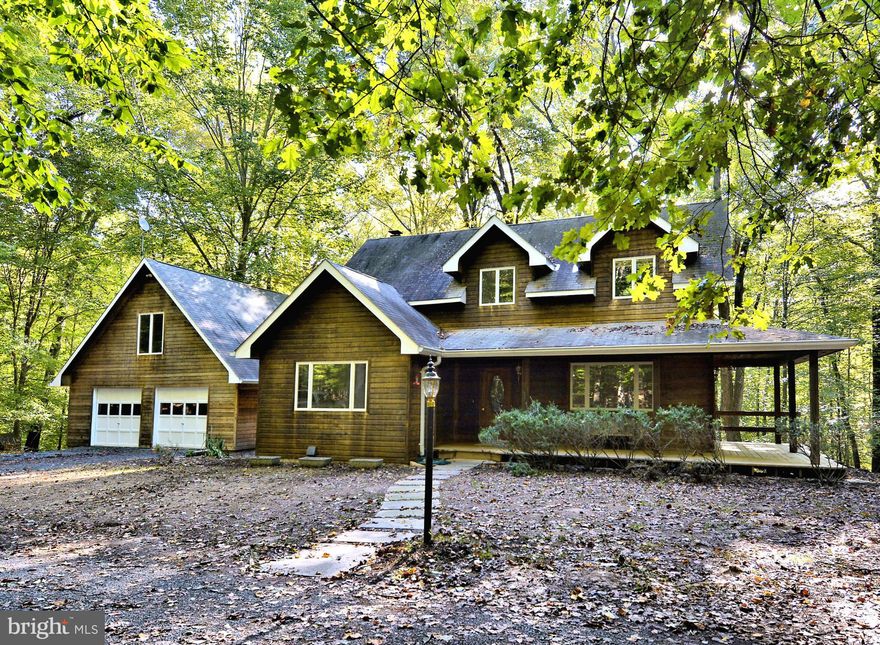 Located just 10 miles from Town of Leesburg!Custom built Cape Cod sited on 4+ wooded acres overlooks creek. Enjoy nature on wrap-around front porch or large deck. 2-car garage w/ 200 SF of storage above. 3-levels of space w/ views of trees from every window brings outside in! Renovated kitchen w/ soft close cabinets, granite, backsplash,SS appliances. Neutral color palettes, new carpet,NEW ROOF.