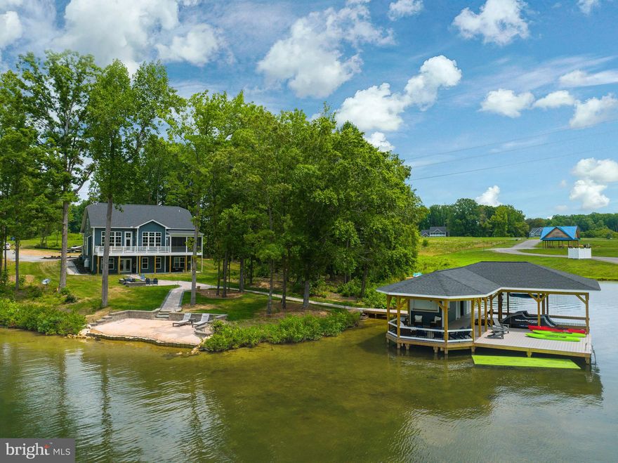 Resort style living in this Luxury Waterfront Retreat, situated along the tranquil shores of Lake Anna in the highly sought after Elk Creek Landing subdivision. High-speed fiber internet is available here! No detail was omitted from this beautiful residence that has 250 ft of shoreline, huge views and the most breathtaking sunsets you'll see on the lake. Open floor plan perfect for entertaining your family and friends. 5 bedrooms, 4 bathrooms and a loft for the kids to hang out. Relax in over 5,500+ spacious square feet with amenities galore, including a floor to ceiling stone fireplace, home theatre, wet bar with an oversized island, upgraded countertops, double wall oven, massive kitchen center island, Luxury Vinyl Plank flooring, recessed lighting, Hardiplank siding, extensive hardscaping and so much more. Stroll down to the water's edge, past the fire pit and step onto your large boat dock with two slips, electric lifts, storage room, tiki bar, sun deck, covered area to relax under and swimming area. At this lake oasis you even have your own private sandy beach! It's the perfect place to grab your float and enjoy hours of fun. This retreat is nestled on 1.5+ acres on the private side of Lake Anna, which offers spectacular open views and calming privacy. Comes furnished so you can move in and immediately start enjoying the lake! Makes a great investment and already has over $91K in vacation rentals booked for 2023. Comes furnished so you can enjoy it right away! At this retreat, you'll also enjoy its incredibly convenient location, roughly 45 minutes from Richmond, 90 minutes from DC, 7 miles from Lake Anna Taphouse, Vito's and Asian Cafe. Less than one mile from Elk Creek Country Store and gas station, and roughly 5 miles from the New Bridge Landing Shopping Center, where you'll find groceries, restaurants, ABC, a nail salon and more. Schedule your tour today!