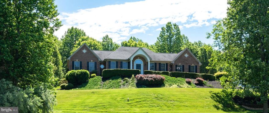 Pristine rambler in  South Wales Community 2 finished levels with many updates Impressive foyer with 12' ceilings and archways Detailed molding throughout Gourmet kitchen with newer stainless steel appliances & gas cooking Granite countertops with breakfast bar Light filled breakfast area with huge bay window Spacious great room has gas fireplace and arched windows  Master bedroom suite with large walk-in closet   2 additional guest rooms  on opposite wing  Lower level features an in-law suite with walk-in closet and full bathroom  Office or 2nd family room with walk -out to private patio area  Huge media room with granite wet bar  Exterior is 3 sides brick Amazing screened in porch Stamped concrete patio areas with hot tub and walkways Lush landscaping and shed Meticulously maintained!