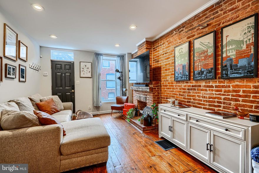 She's small but mighty! This charming 2BR/1.5BA Riverside rowhome has stunning rooftop views of the iconic Domino Sugar sign. Sweeping vistas of the harbor and city give a 360-degree view of downtown from sunrise to sunset! Steps from the waterfront, this rare gem is walking distance to Federal Hill, Riverside Park, and all that Locust Point has to offer! Fully updated with exposed brick, granite counters, stainless steel appliances, reverse-osmosis water filter, and front-loading W/D on the upper level. Bonus in-home office off the kitchen. Fireplace is decorative only. New water heater in 2025.
