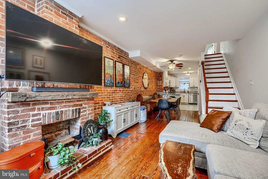 She's small but mighty! This charming 2BR/1.5BA Riverside rowhome has stunning rooftop views of the iconic Domino Sugar sign. Sweeping vistas of the harbor and city give a 360-degree view of downtown from sunrise to sunset! Steps from the waterfront, this rare gem is walking distance to Federal Hill, Riverside Park, and all that Locust Point has to offer! Fully updated with exposed brick, granite counters, stainless steel appliances, reverse-osmosis water filter, and front-loading W/D on the upper level. Bonus in-home office off the kitchen. Fireplace is decorative only. New carpet on upper level and LVP flooring in office (2026). New water heater (2025).