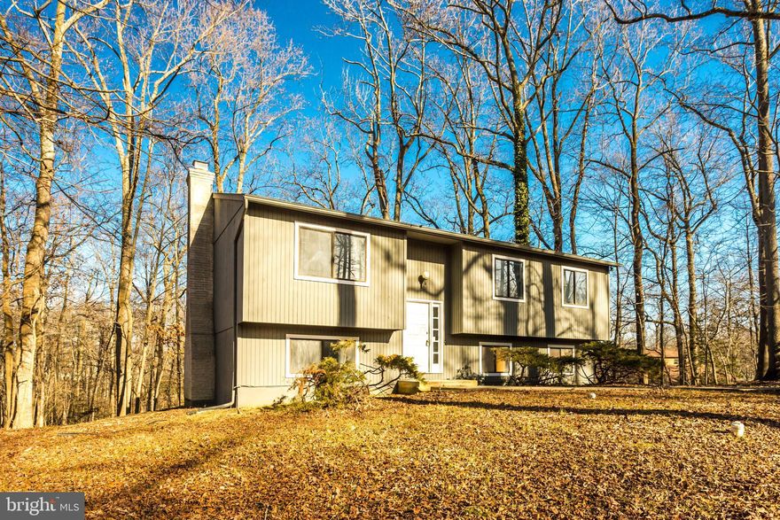 Beautifully renovated home on a wooded lot at the end of a cul-de-sac, in Walnut Lake subdivision. Bright eat-in kitchen with granite countertops, tile back splash and stainless steel appliances with a sliding glass door leading out to the deck. All new flooring throughout and new windows. The upper level has 3 bedrooms  and 2 full baths. Lower level is partially finished with a family room and walk out to rear.  Large utility room/laundry room with storage space. Great location close to restaurants, shopping and marinas. Only 10 minutes to downtown Annapolis.