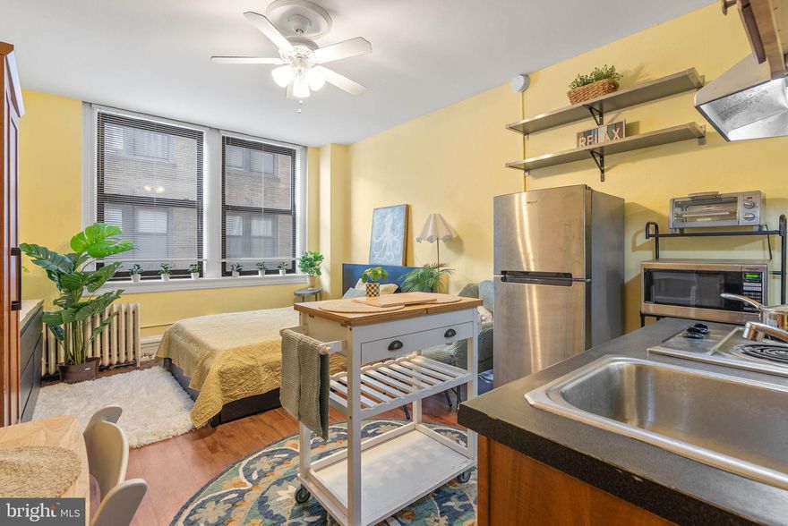 Discover Unit 703 at the Arts Condominium—a bright, efficient studio set right in the middle of Center City. This location puts you steps from the Avenue of the Arts and surrounded by endless dining, entertainment, and transit options, ideal for anyone who wants easy access to the best of Philadelphia.

Inside, the layout is more functional than most studios in this price point, with wide windows that bring in consistent natural light, a full tiled bathroom with a tub and storage vanity, and a surprisingly roomy closet. The seller is also willing to include several useful pieces: a full-size refrigerator, a standalone pantry, and a rolling breakfast cart, along with select furniture if desired. These additions make the space immediately practical for someone looking for a turnkey setup.

Residents enjoy a solid list of building amenities—24-hour front desk, elevators, an on-site gym, a laundry room, and common areas. Nearly everything you need is in the building or right outside the front entrance.

If convenience, walkability, and overall value are high on your list, this studio offers a straightforward, well-located option in the center