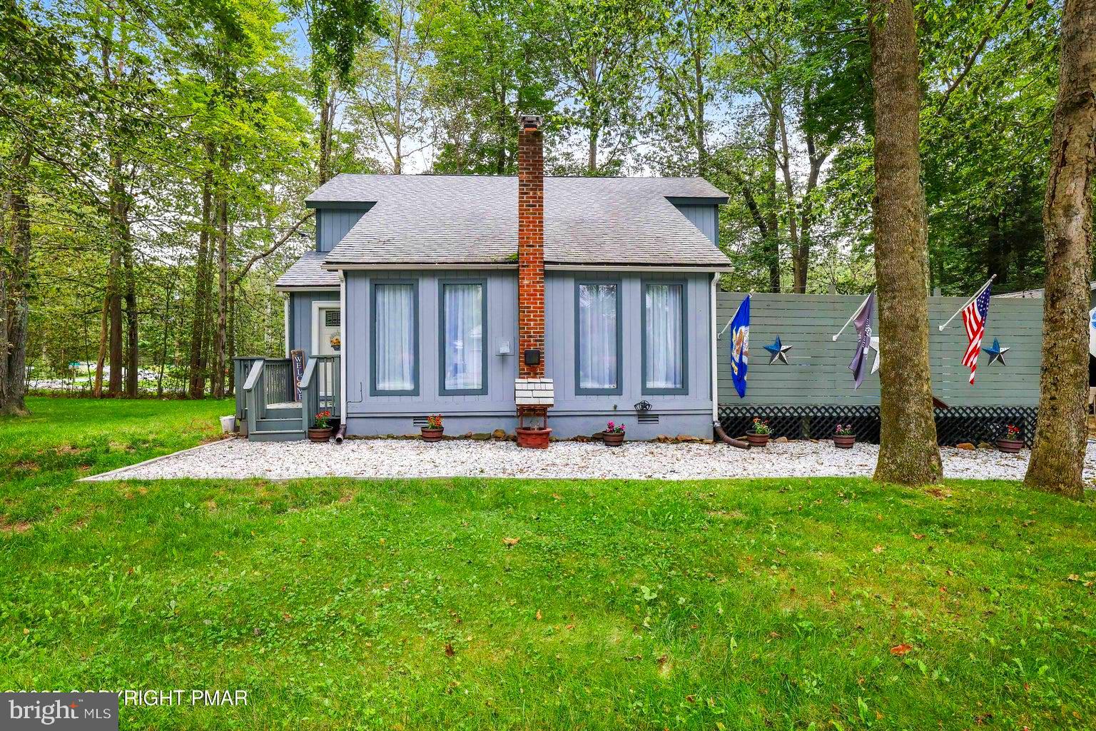 Welcome to your perfect Pocono retreat! This beautifully maintained 3-bedroom, 2-bath contemporary home sits on over half an acre, offering peace, privacy, and plenty of space to relax or entertain. Inside, you'll find a bright and open layout featuring a newly updated full bath, brand new flooring, and a stylish modern aesthetic throughout. Step outside to the absolutely gorgeous deck, complete with a hot tub—ideal for soaking under the stars. A large garage provides plenty of room for vehicles, storage, or even a workshop. Whether you're looking for a full-time residence, weekend escape, or investment property, this move-in ready gem is a must-see in the heart of the Poconos.