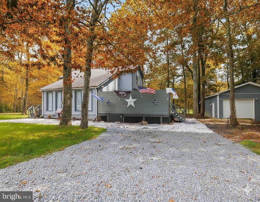 Welcome  Home! This beautifully maintained 3-bedroom, 2-bath contemporary home sits on over half an acre, offering peace, privacy, and plenty of space to relax or entertain. Inside, you'll find a bright and open layout featuring a newly updated full bath, brand new flooring, and a stylish modern aesthetic throughout. Step outside to the absolutely gorgeous deck, complete with a hot tub—ideal for soaking under the stars. A large garage provides plenty of room for vehicles, storage, or even a workshop. This home shows pride in ownership and is a must-see!