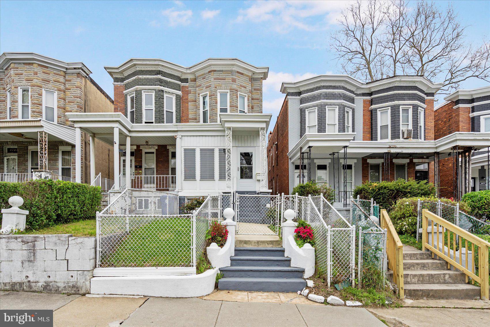 Welcome to 3023 Belmont Ave – a charming two-story semi-detached townhouse located in the Rosemont neighborhood of Baltimore City. This well-maintained 3-bedroom, 1-bath home offers spacious bedrooms, a formal dining room, and original wood floors full of character. Cozy up by the electric fireplace or enjoy extra space in the finished basement—great for rec area and storage.
Step outside to a screened-in front porch, perfect for relaxing, and a second porch off the third bedroom. The kitchen includes a pantry space with potential to convert into a powder room. Also an enclosed area in the rear of the kitchen that leads to the yard and garage. Additional updates include an alarm system for added peace of mind, nearly new furnace and water heater, windows installed in 2007, and roof recoated in 2022.
While there’s no central air, ceiling fans and window A/C units provide comfort year-round. Full of original charm and waiting for your personal touch, this home is a solid opportunity for homeowners or investors alike!