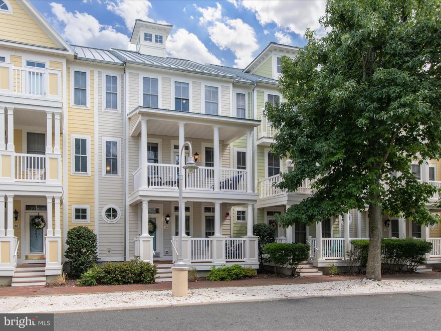 Introducing 36 Beach Side Dr., an exquisite coastal retreat nestled within the prestigious, amenity-rich, gated community of Sunset Island, just minutes from the vibrant Ocean City resort. This stunning home offers an idyllic blend of coastal charm and modern luxury, all set within a community that feels like a quaint Southern town, complete with picturesque streetscapes and walkable paths that lead you to a premier bayfront resort—boasting amenities unparalleled in Ocean City. This residence spans four levels of thoughtfully designed living and entertaining spaces, each floor embodying coastal elegance with architectural finishes, fine features, and custom lighting throughout. Every level also offers its own outdoor living area, inviting you to take in the scenic vistas and charming streetscapes of this extraordinary environment. Inside, you’ll find four bedrooms, four full baths, and one-half bath, making this home perfectly suited for gatherings of any size. The main living area features a light-filled living room that opens to the front balcony through French doors, seamlessly blending indoor and outdoor living. The gourmet kitchen is a chef’s delight, with granite countertops, a suite of stainless steel appliances, and abundant cabinetry to house all your culinary essentials. Dining options abound, whether at the breakfast bar, in the adjacent dining area, or alfresco on the rear balcony. The two upper levels include a primary suite with a spa-like ensuite bathroom, complete with a dual vanity, stall shower, deep soaking tub, and walk-in closet. Two additional guest bedrooms and a fully appointed bathroom provide ample space for family and friends. The top floor serves as a private retreat, offering a spacious bedroom area, sitting area, ensuite, and its own balcony—perfect for savoring your morning coffee or evening cocktail. The entry level of the home welcomes you with a gracious foyer off the front porch, a beautifully appointed flex room with custom built-ins, a full bathroom, laundry room, and interior access to the two-car garage, which provides abundant storage for all your beach toys and coastal gear. This property presents an incredible opportunity, not only as a cherished gathering place for friends and family but also as a lucrative rental residence in this sought-after Ocean City resort town. Sunset Island is a community like no other, offering 24-hour security, indoor and outdoor pools, a convenience store, fitness center, clubhouse with a restaurant, private bay beach, walking and biking paths, and a fishing/crabbing pier.  Here, you can watch spectacular bay sunsets, take leisurely evening strolls along the clamshell walkways, enjoy movie nights with ice cream by the water, participate in annual events like the 4th of July parade or Easter Egg hunt, or head to the beach just a few blocks away. Don’t miss your chance to own in this coveted community—this home won’t last long!
